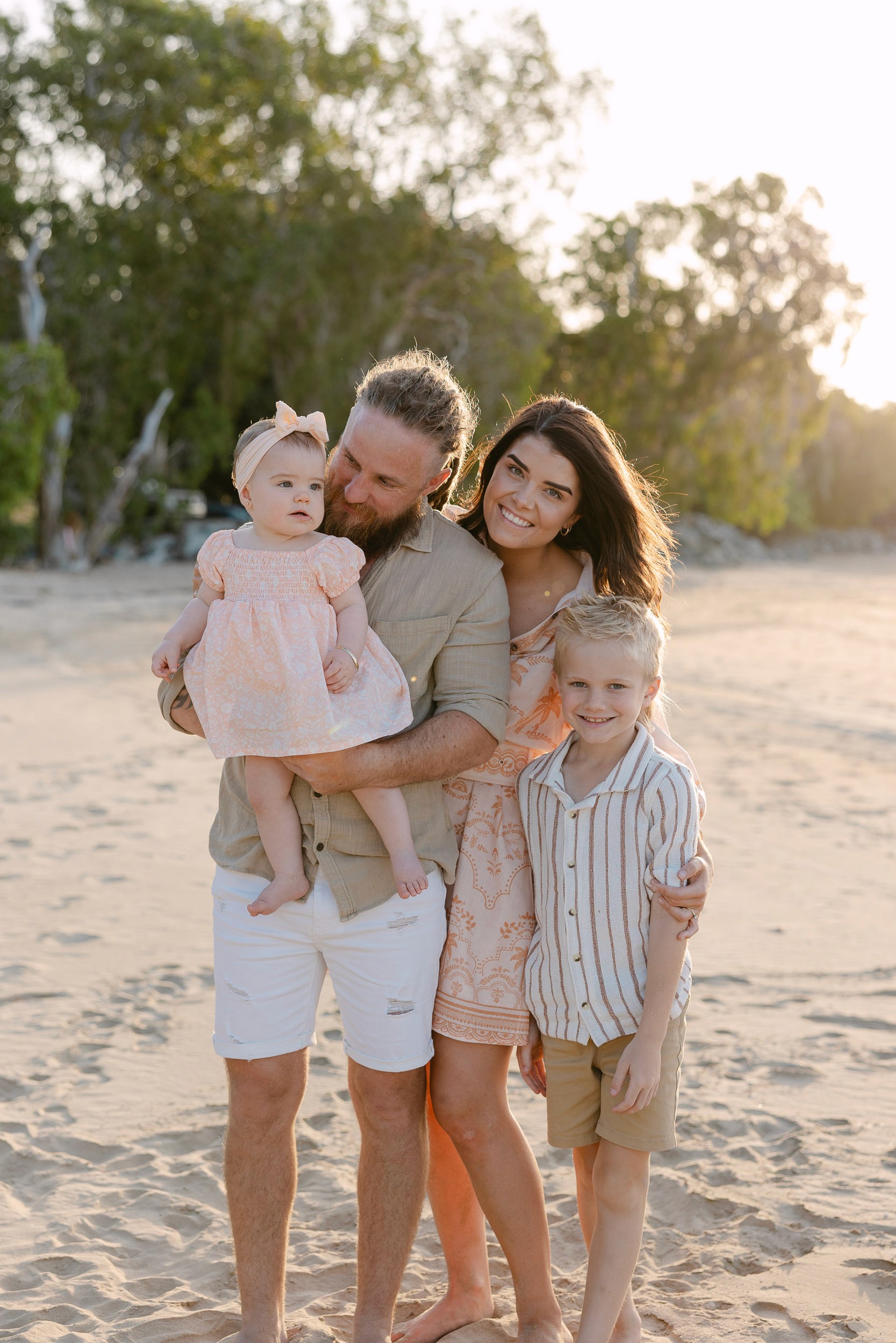 Family on the beach in soft sunlight in Mackay