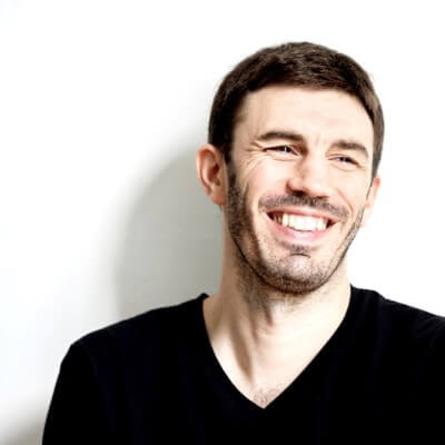 smiling woman wearing white and black pinstriped collared top