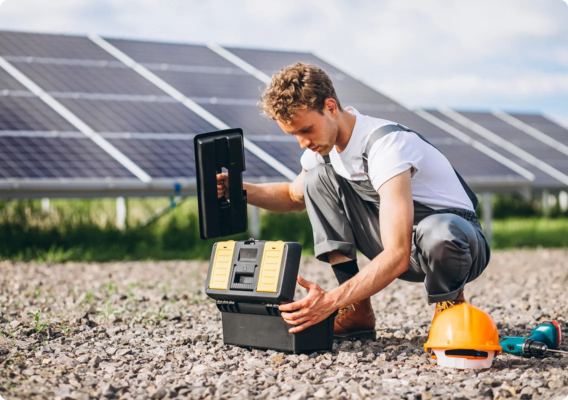 Technician unpacking toolbox for solar repair and monitoring in a field array