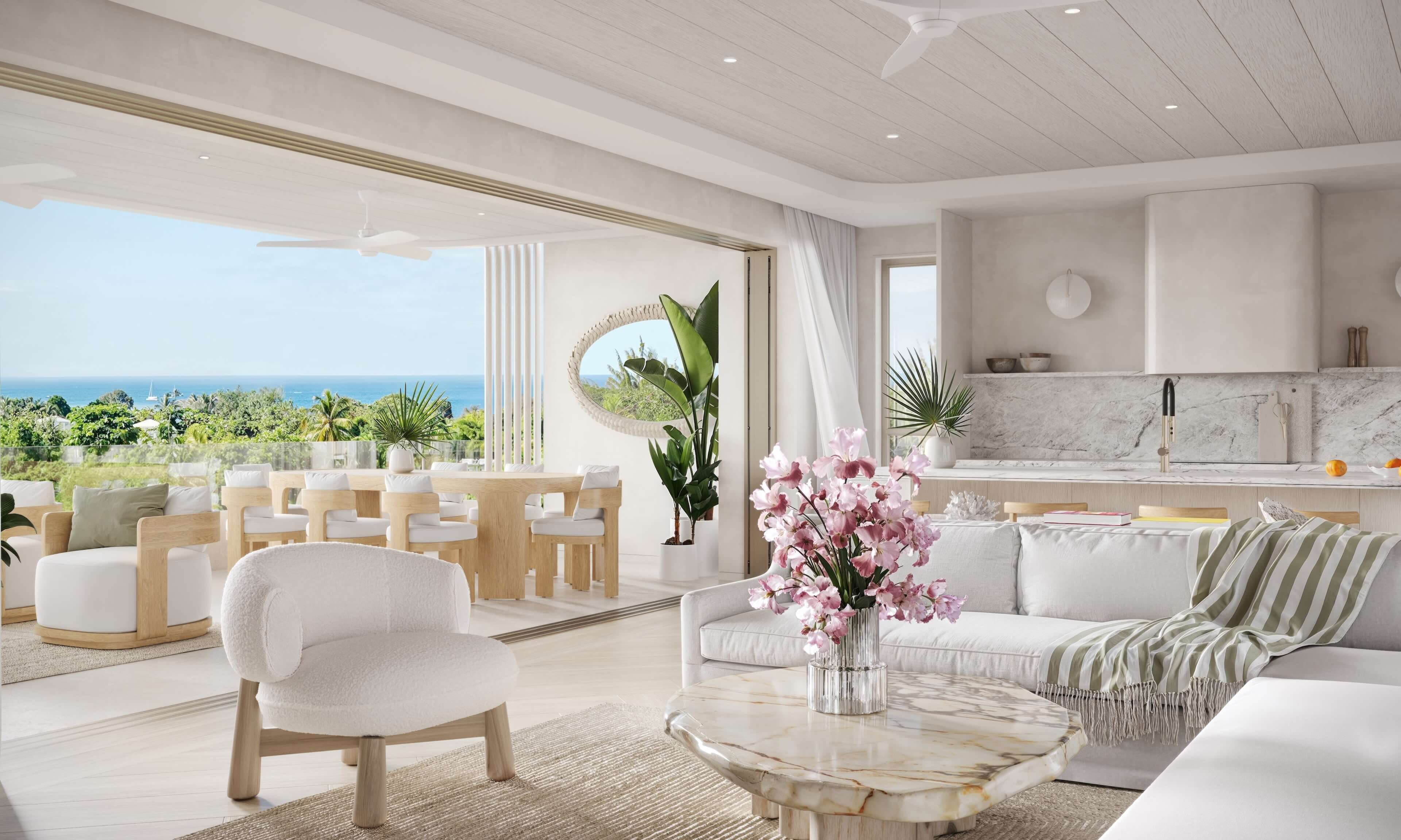 Bright, modern living room with white furnishings, open space, and a view of lush greenery outside.