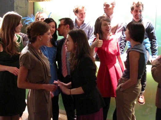 a bunch of people taking socializing while being at the exhibition