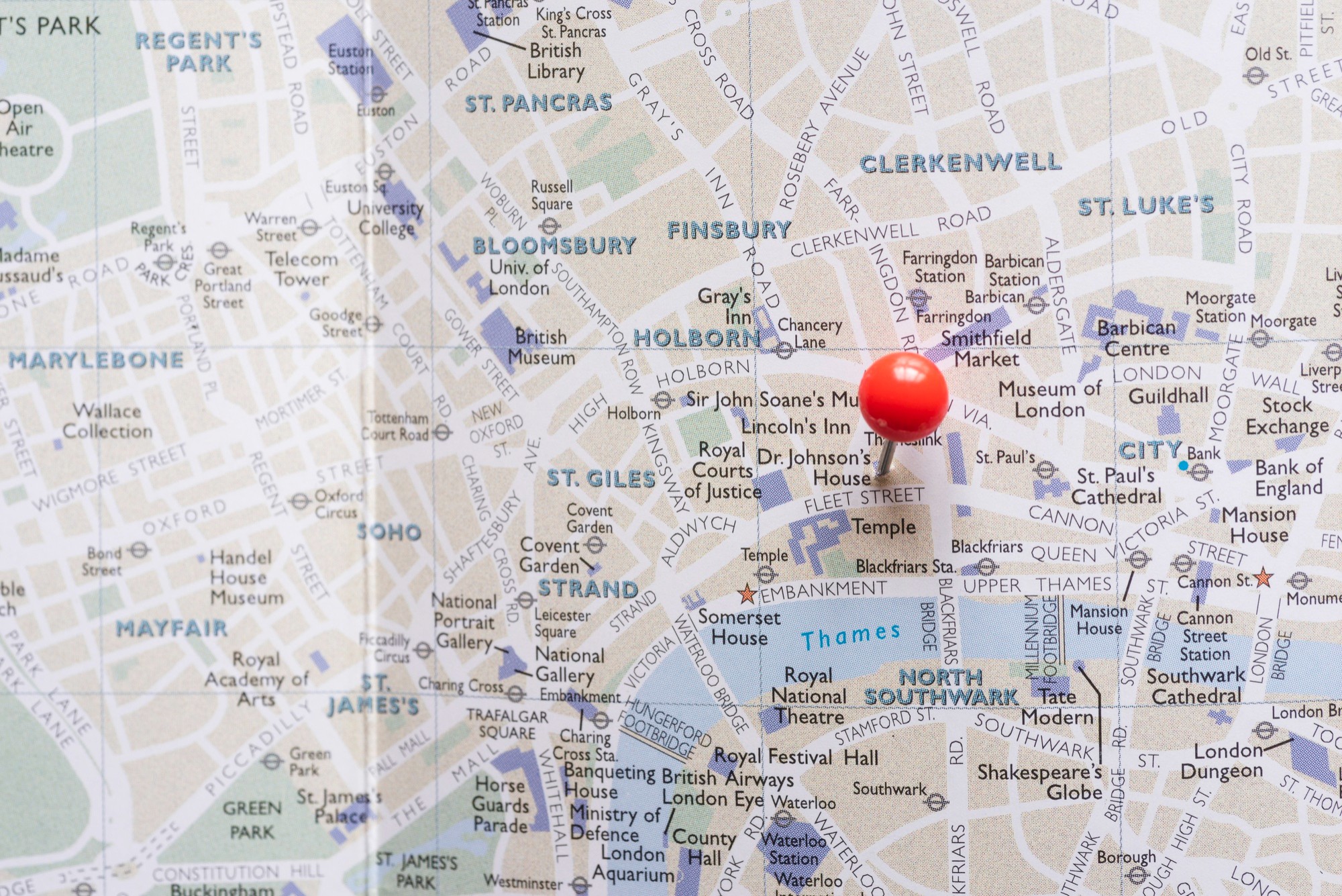 A close-up view of a London map with a red pin.