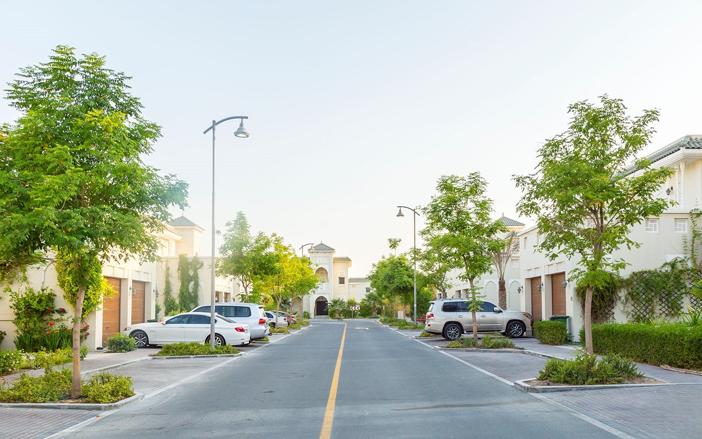 Quiet residential street in Nad Al Hamar with modern townhouses and villas, perfect for new home buyers.