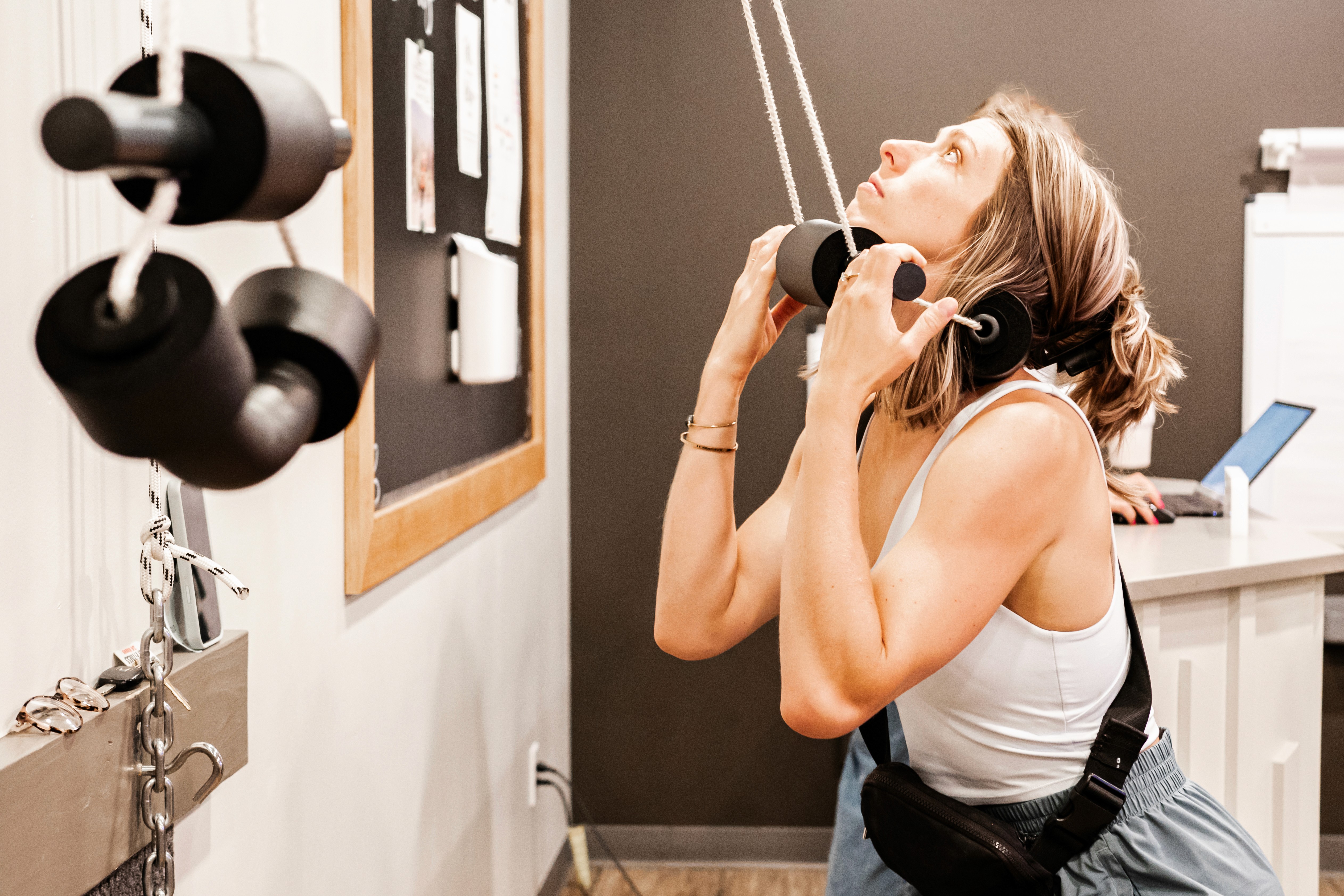 A white ramekin filled with chocolate mousse and topped with strawberries on a table. 