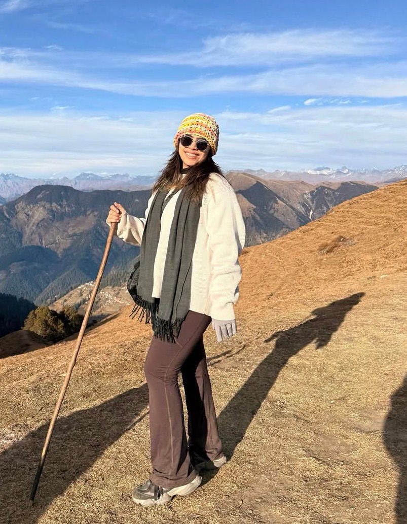 selective focus photo of man standing holding DSLR camera
