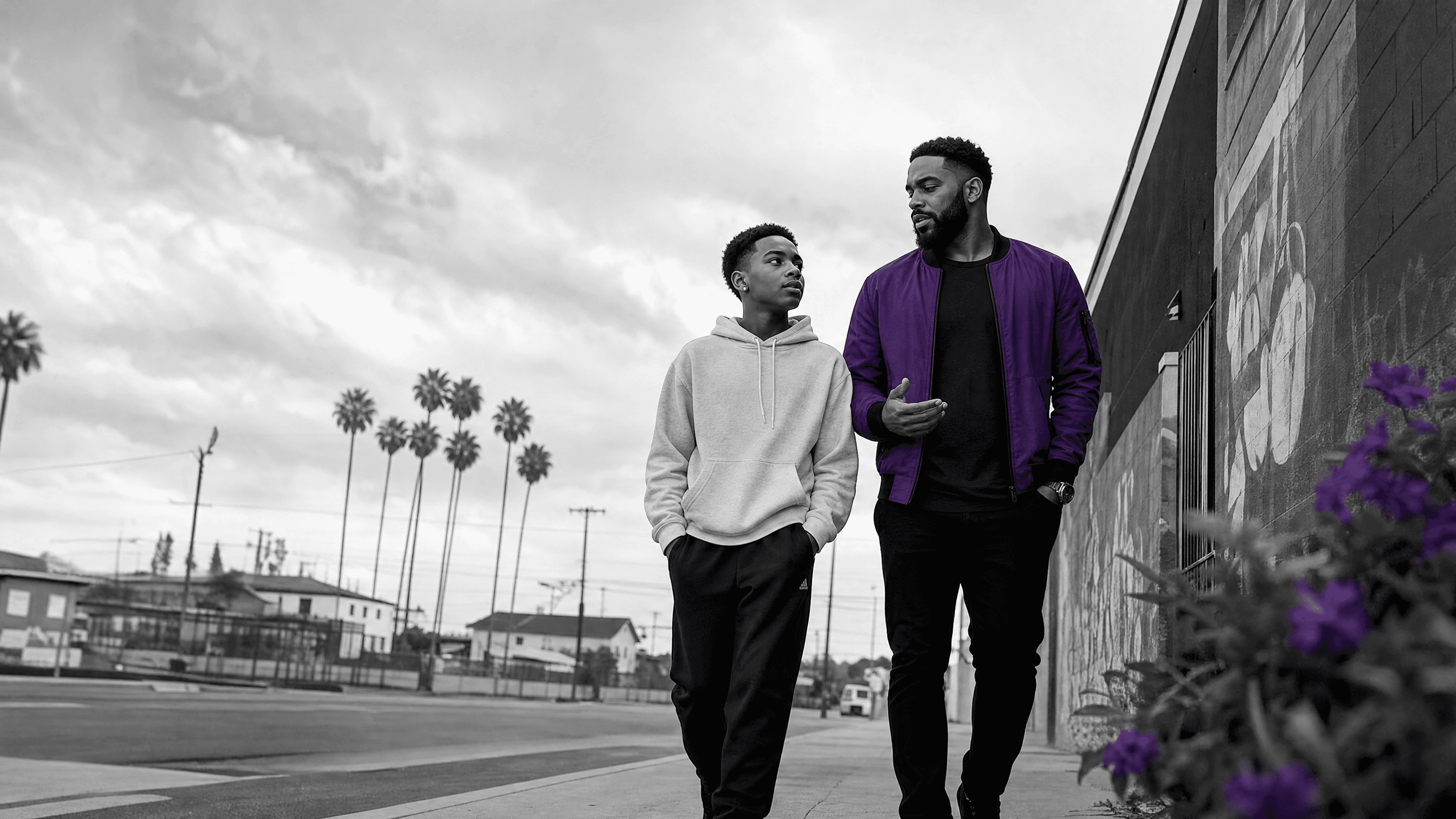 Two people walking together through a South Los Angeles community.