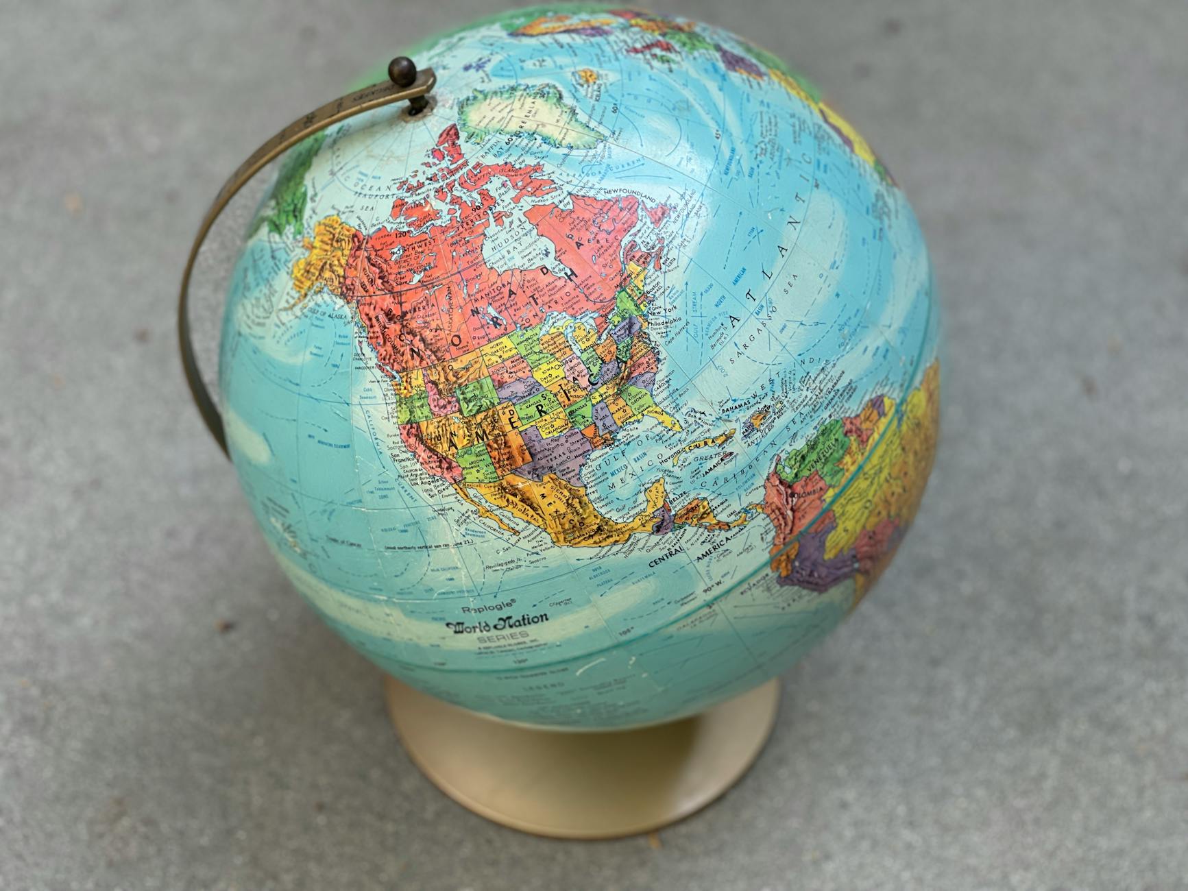 Split screen showing a vintage American flag on one side and a classic globe on the other.