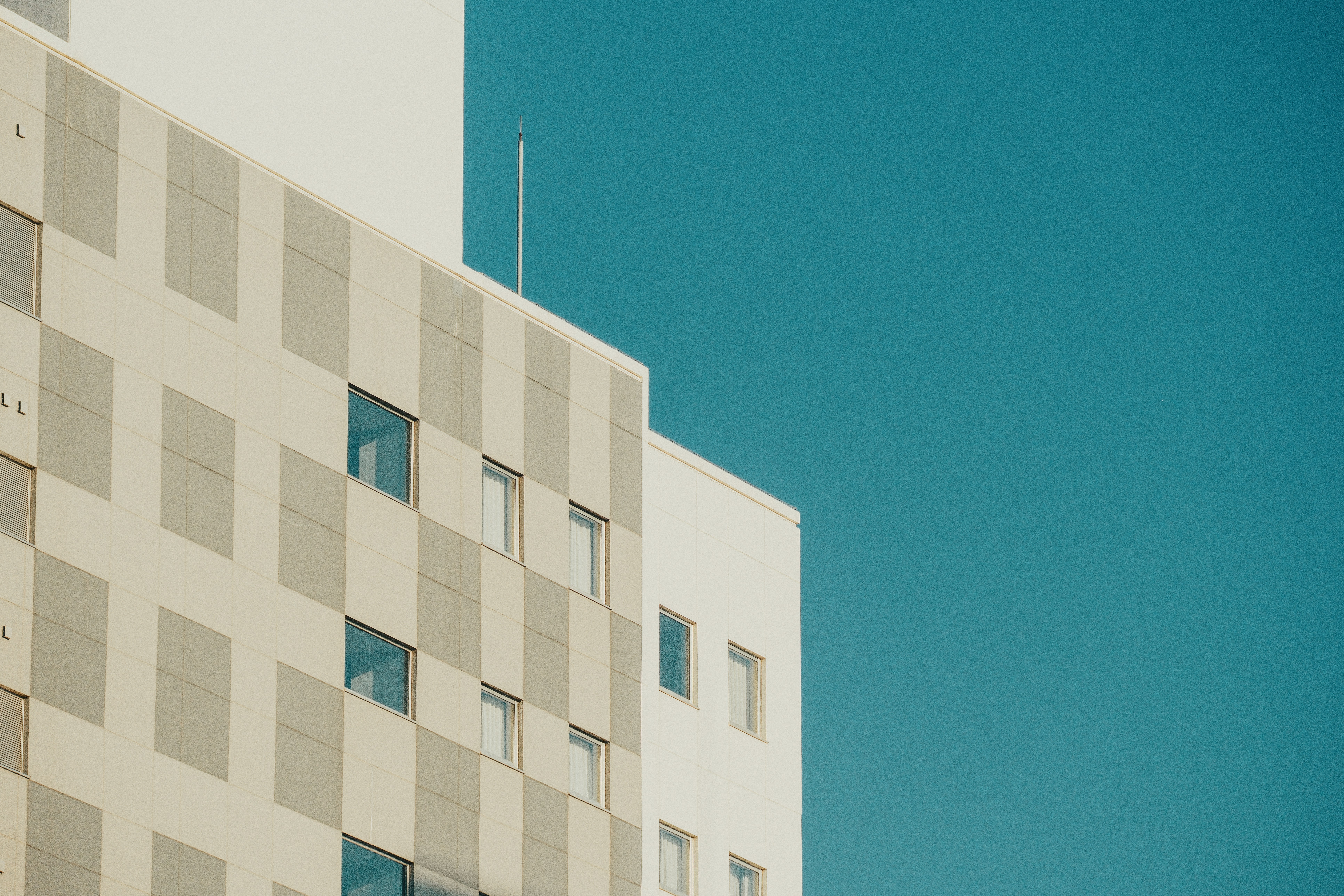 Modern building facade against a clear blue sky