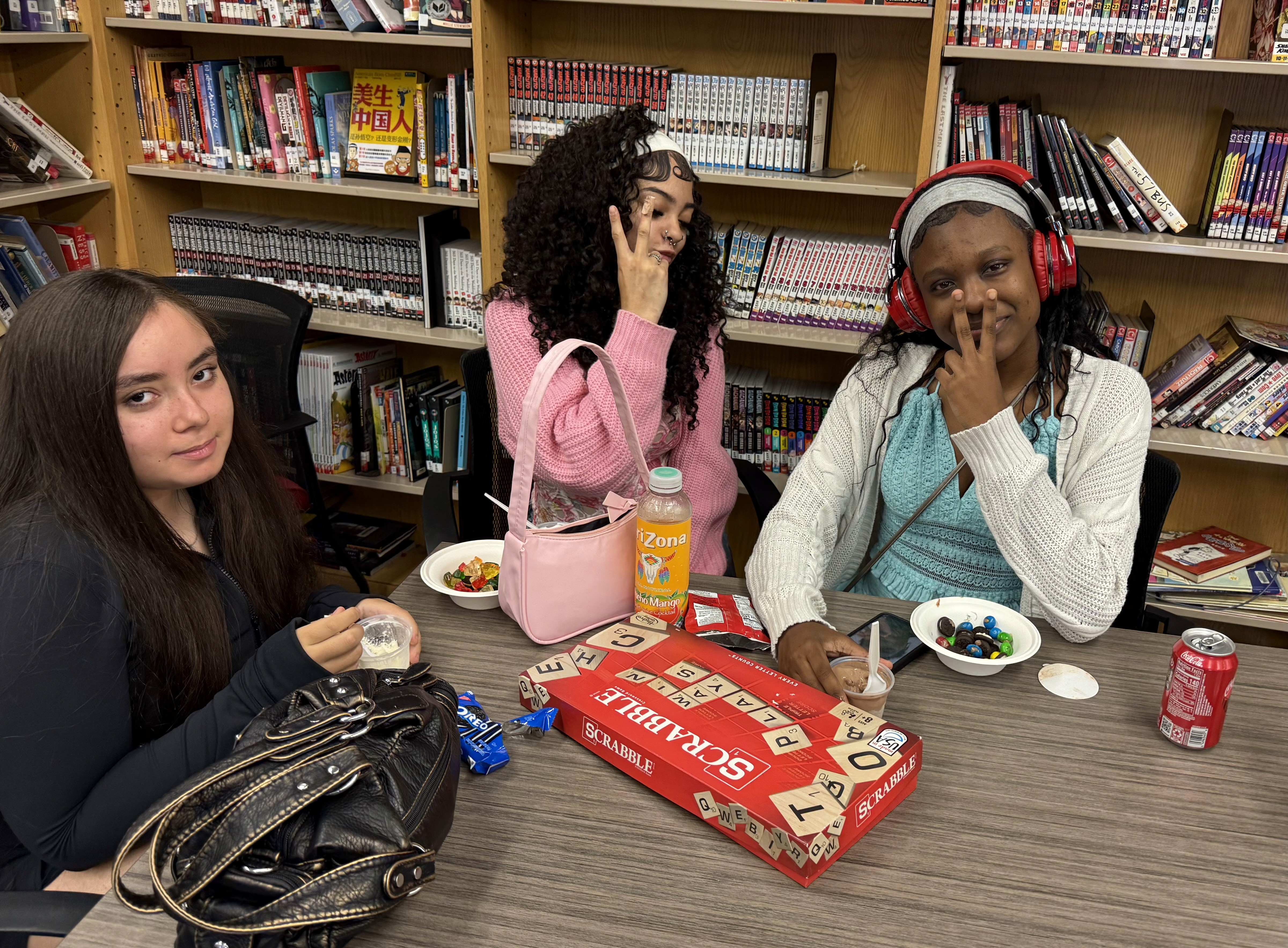 Teens pose with their games and ice cream.