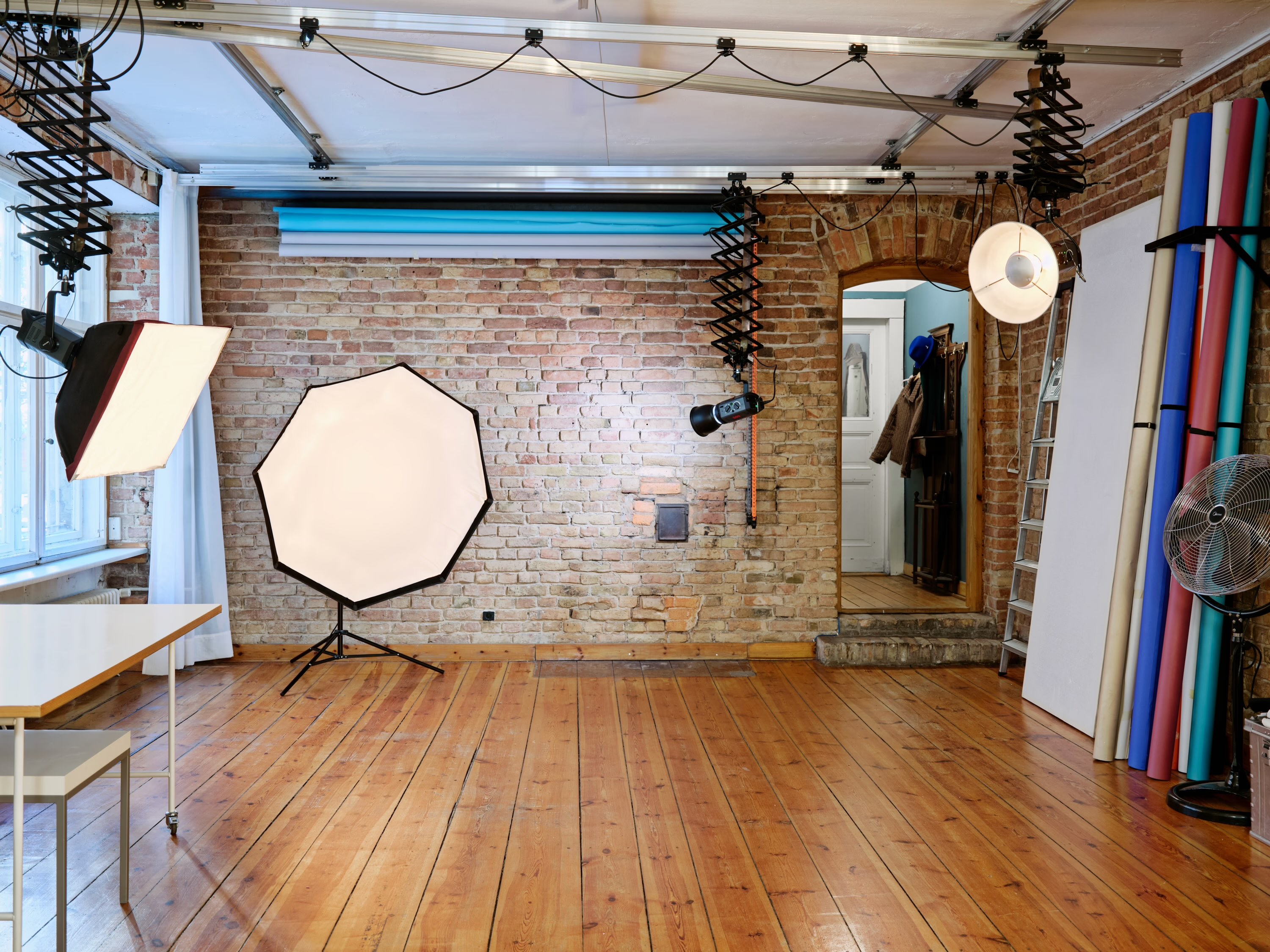 A group of five young adults poses together in a bright, modern indoor space, smiling and enjoying their time.
