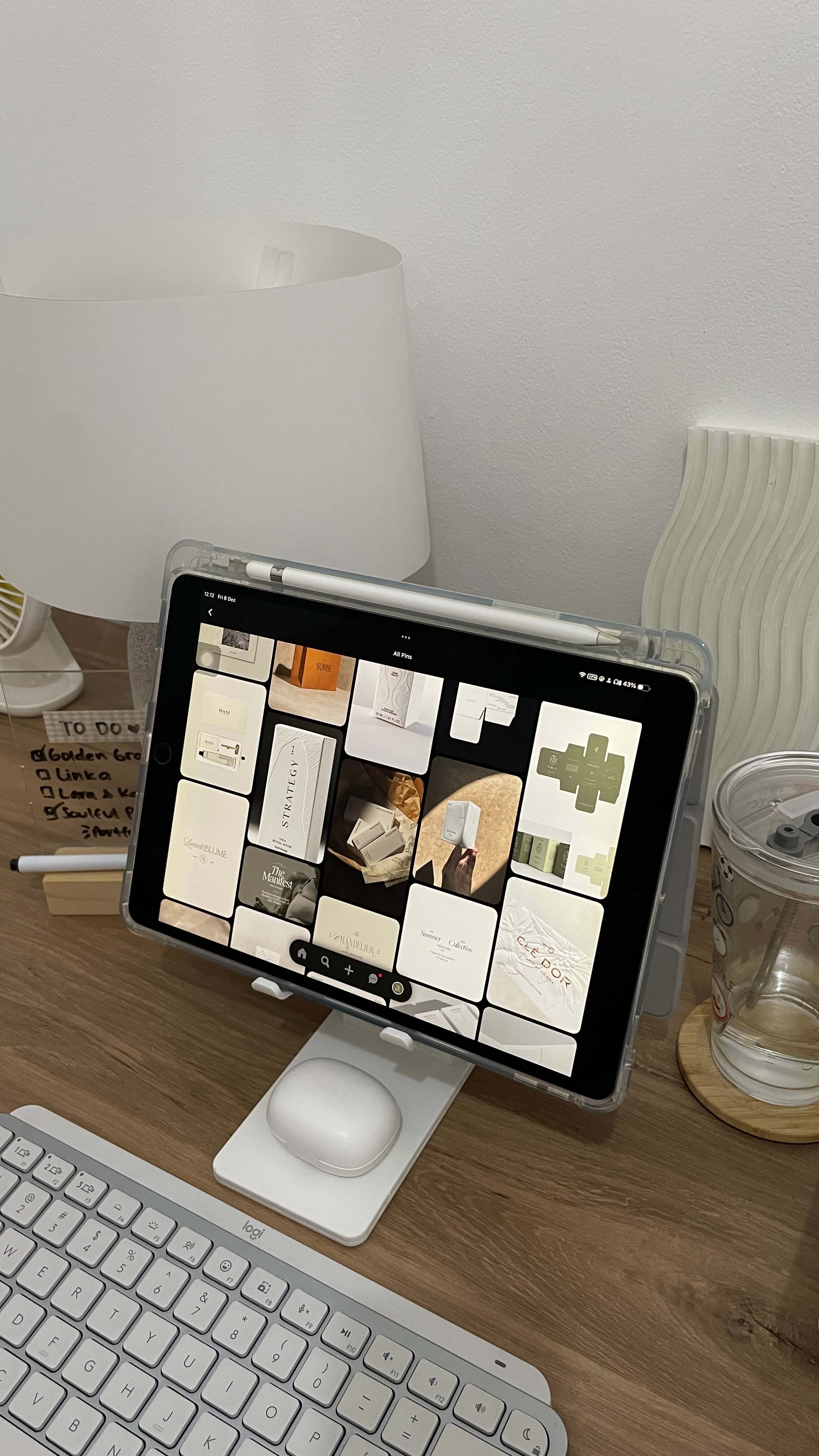 a wooden desk with an ipad displaying a interest board