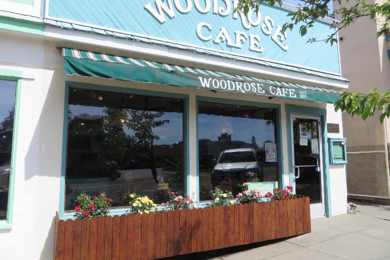 The blue Woodrose Cafe storefront and flower-filled window boxes in Garberville.