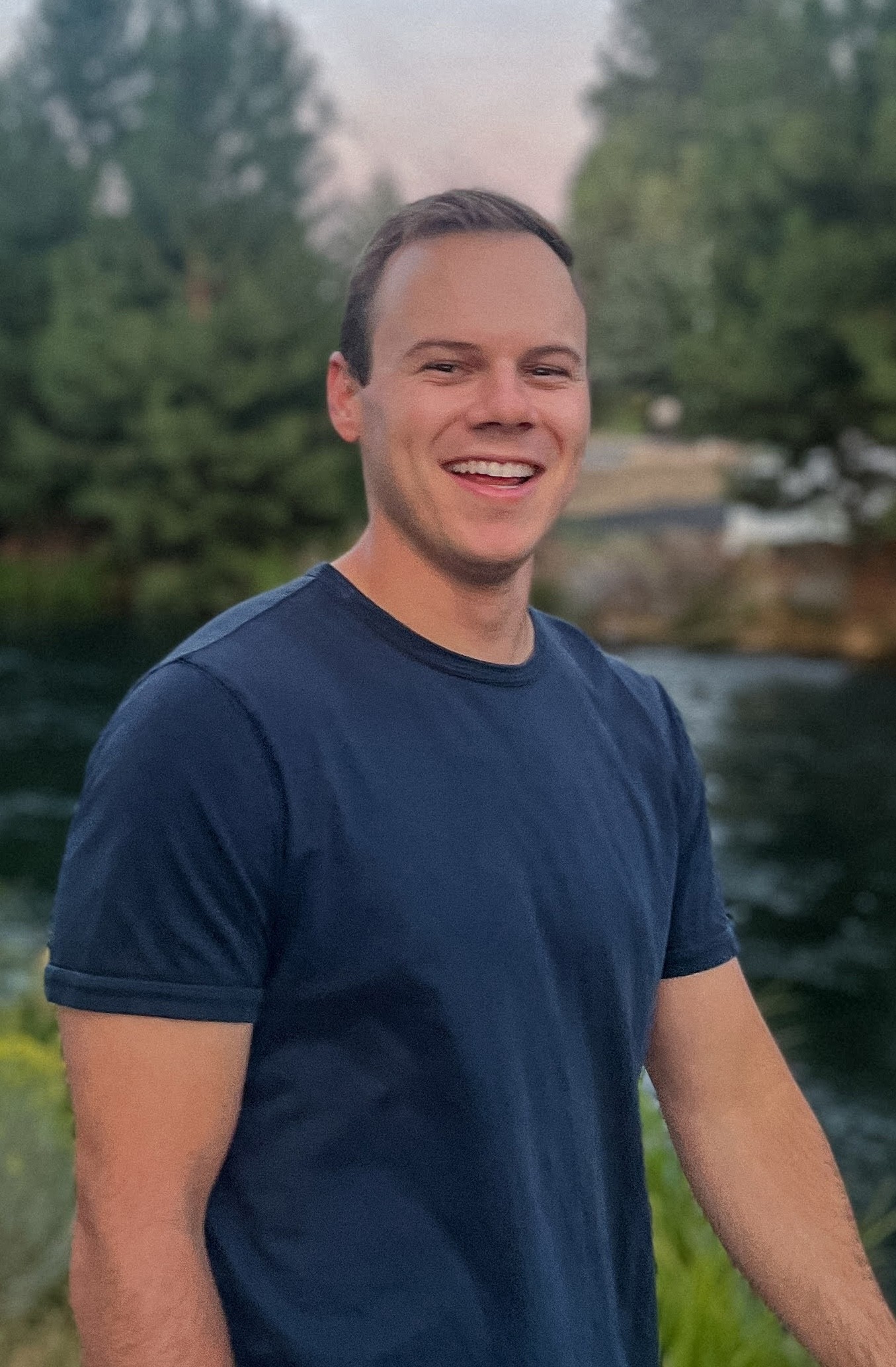 Headshot of Simon Stauber with trees in the background