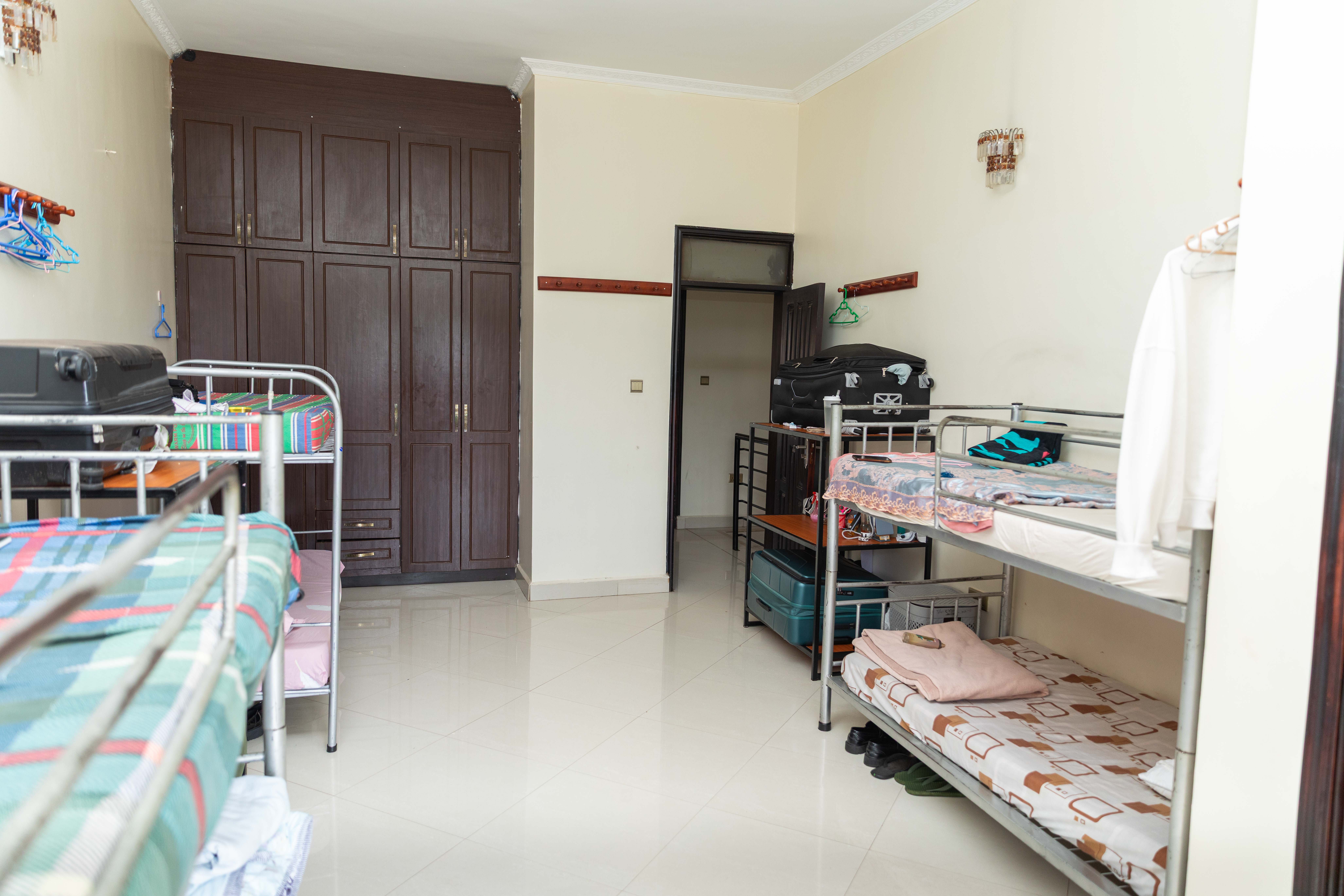 A student stands with a backpack on, ready for school