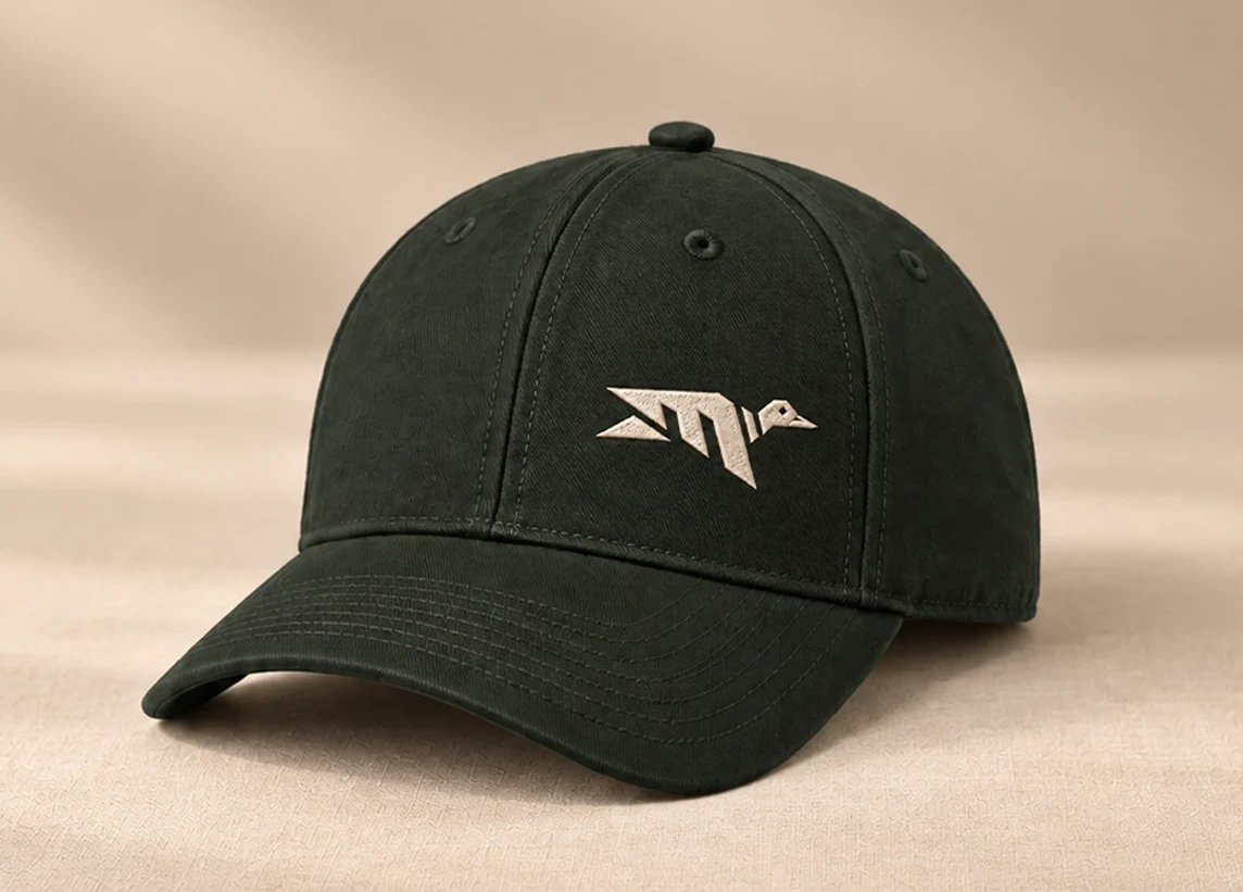 Dark green Mallard Club cap with embroidered mallard logo on a tan background