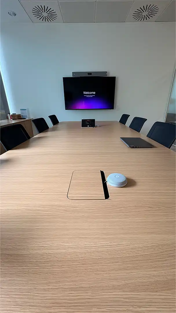Meeting room with wall-mounted display and conferencing system