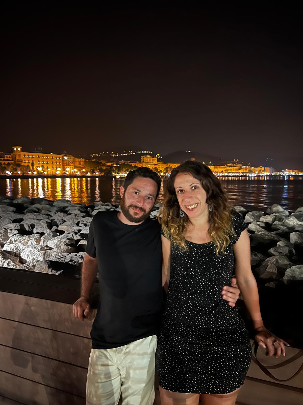 A woman in jeans jacket, holding a camera.