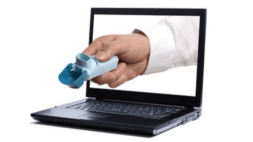 Hand holding an inhaler emerging from a laptop screen, symbolizing telemedicine and digital healthcare.