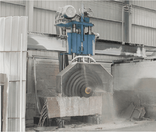 The Intelligent Bridge Multiblade Cutting Machine in action, showcasing its multi-blade cutting capability on a large granite block, set in a well-lit industrial facility.