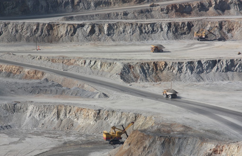 a field with trucks carrying excavated raw material