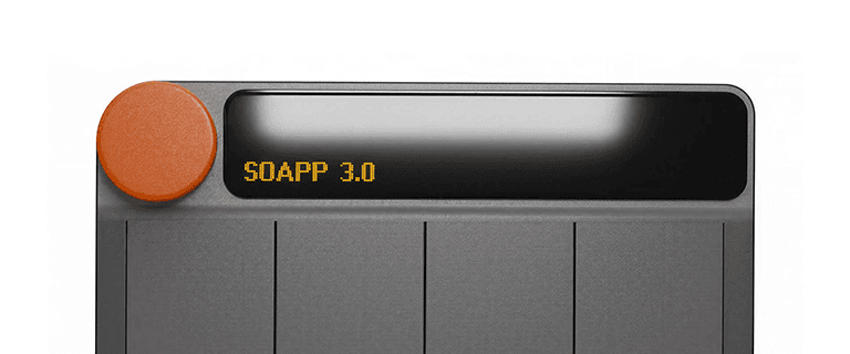 Front view of the Riff MIDI Link with a white illuminated display showing the text “SOAPP 3.0” in orange pixel lettering on a transparent background.
