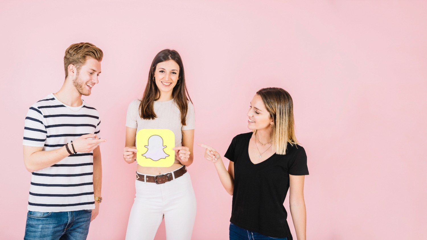 Three individuals joyfully holding a Snapchat sign, showcasing their enthusiasm for the social media platform.