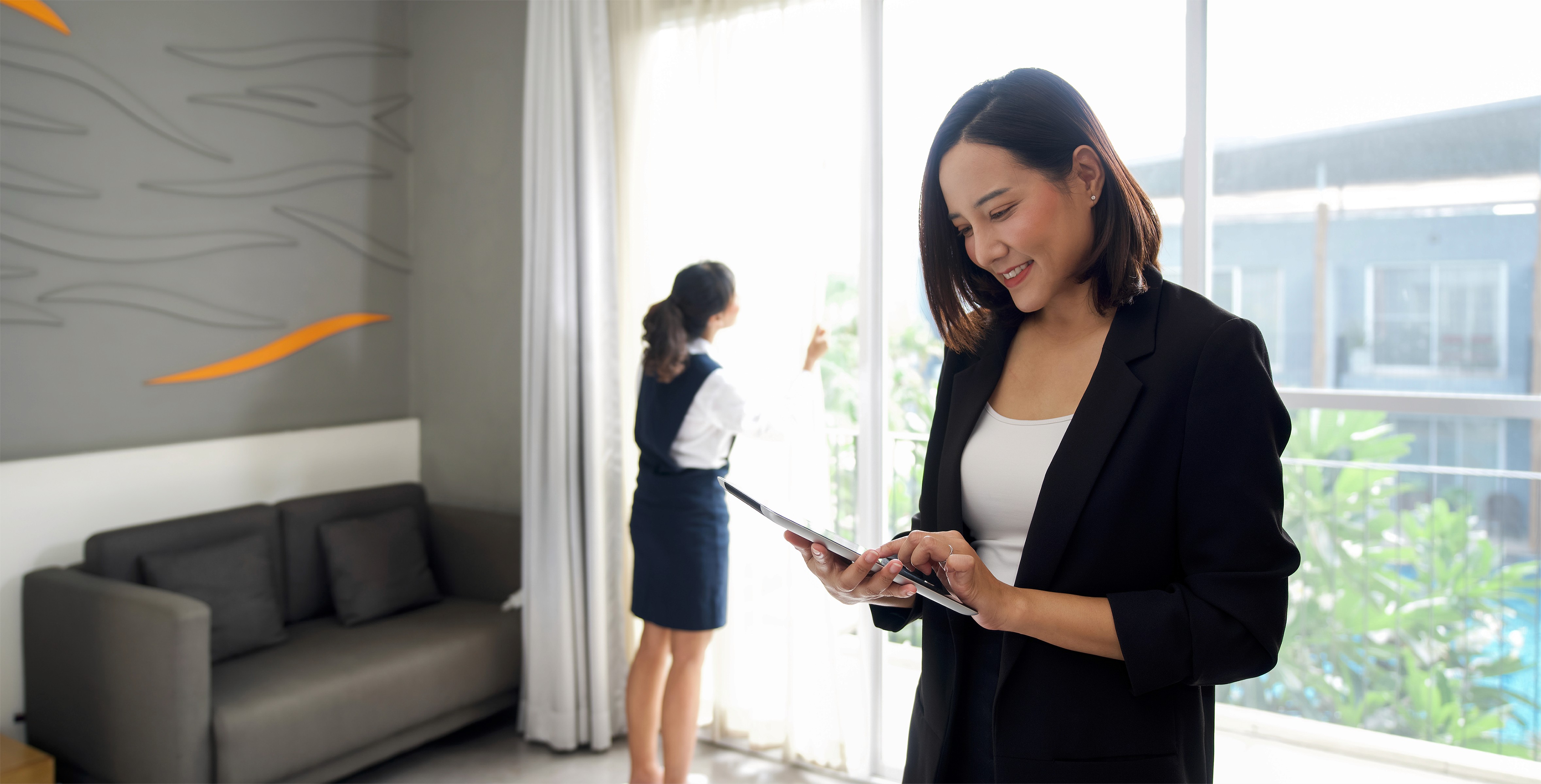 Female property manager reviewing tenant and rental balance data on a phone, representing comprehensive property management services.