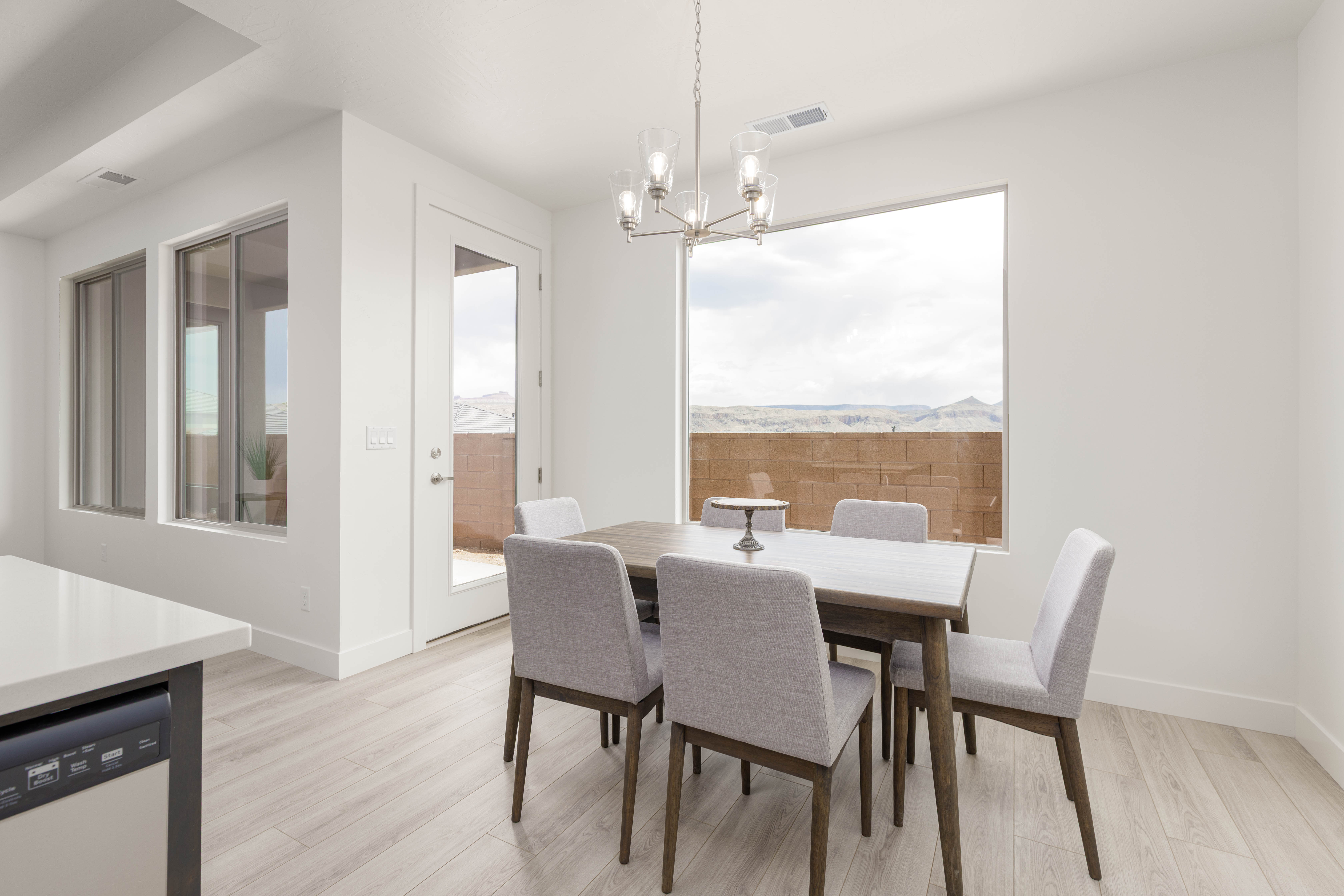 Bright dining room adjacent to kitchen in The High Desert Home new construction home in Hurricane Utah.