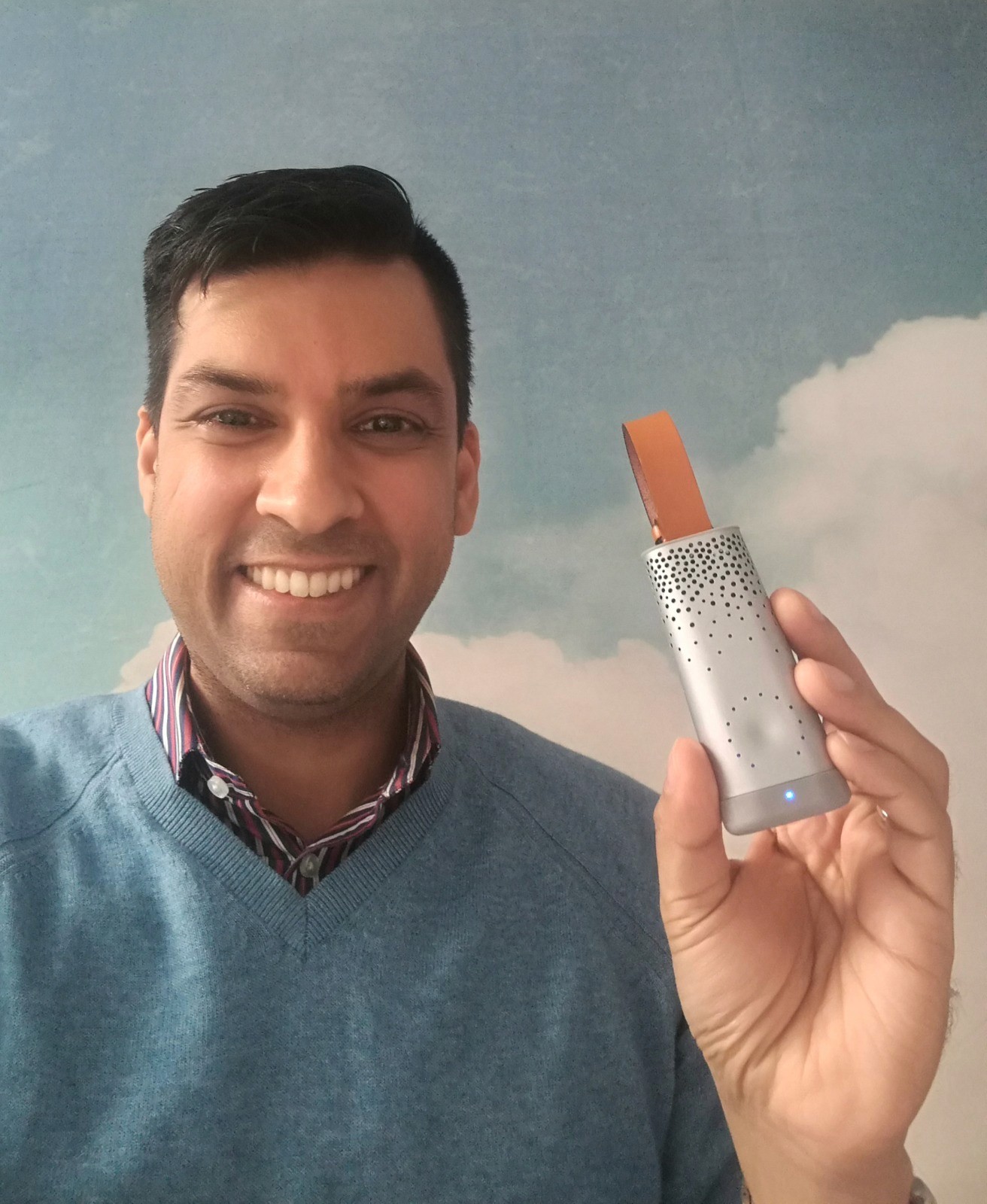 (Image: Faizal demonstrating a portable air quality sensor as part of a pilot project with an environmental agency and technology partner.)