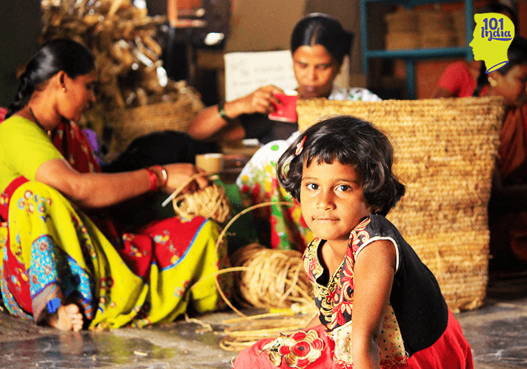A child plays as the mother works