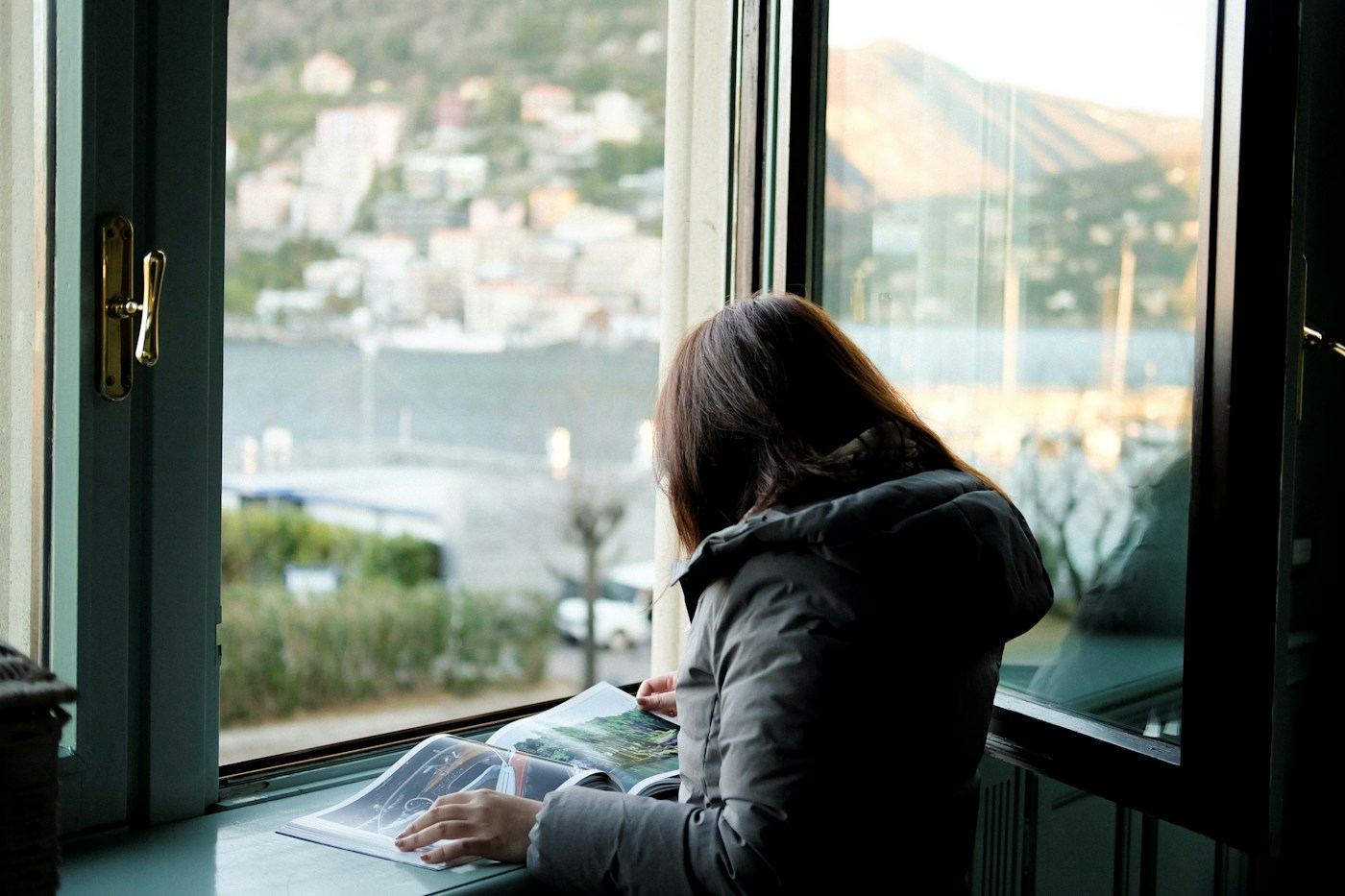 designer sketching layouts on paper at a quiet desk by a window