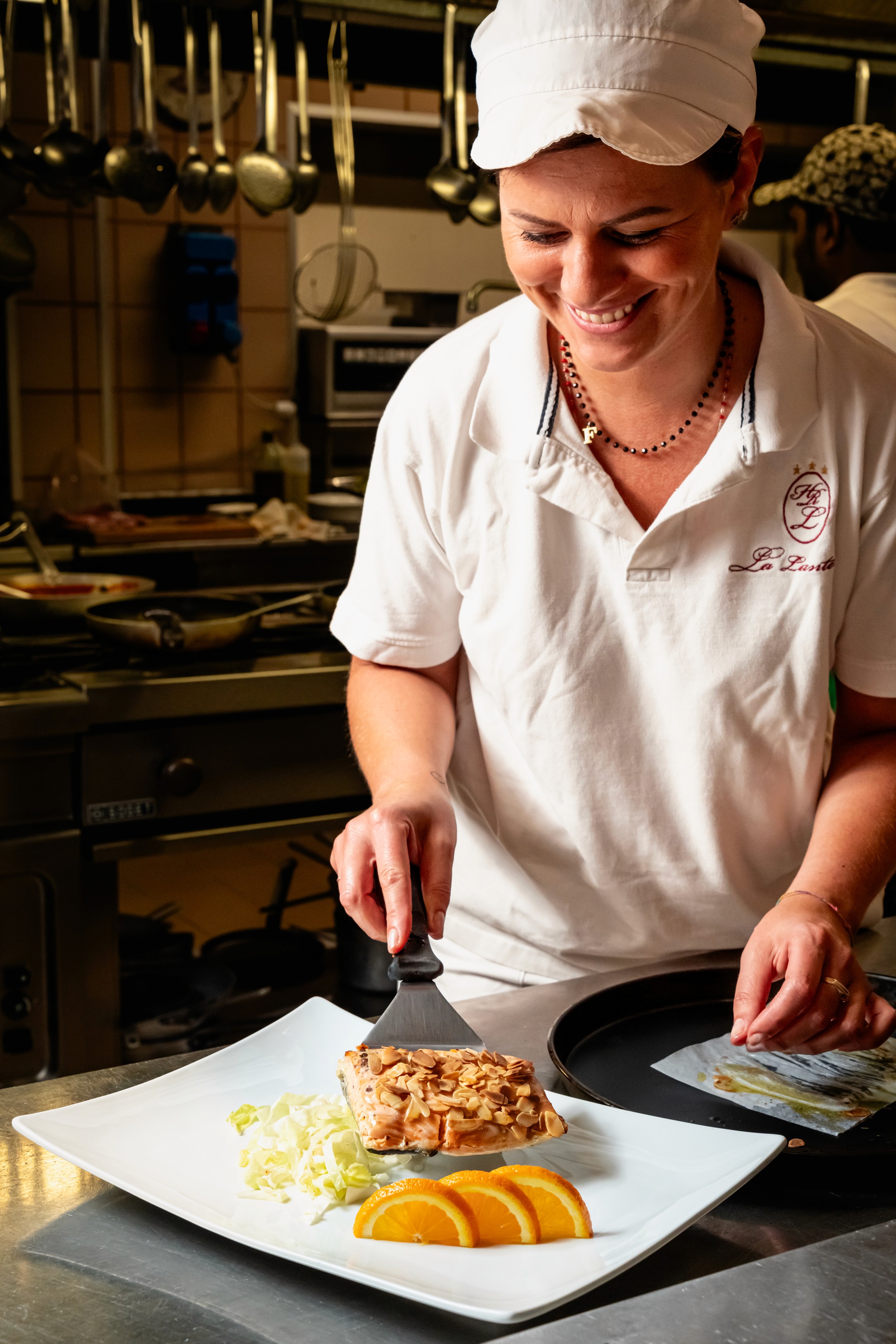 Cuoca che cucina al ristorante la lanterna