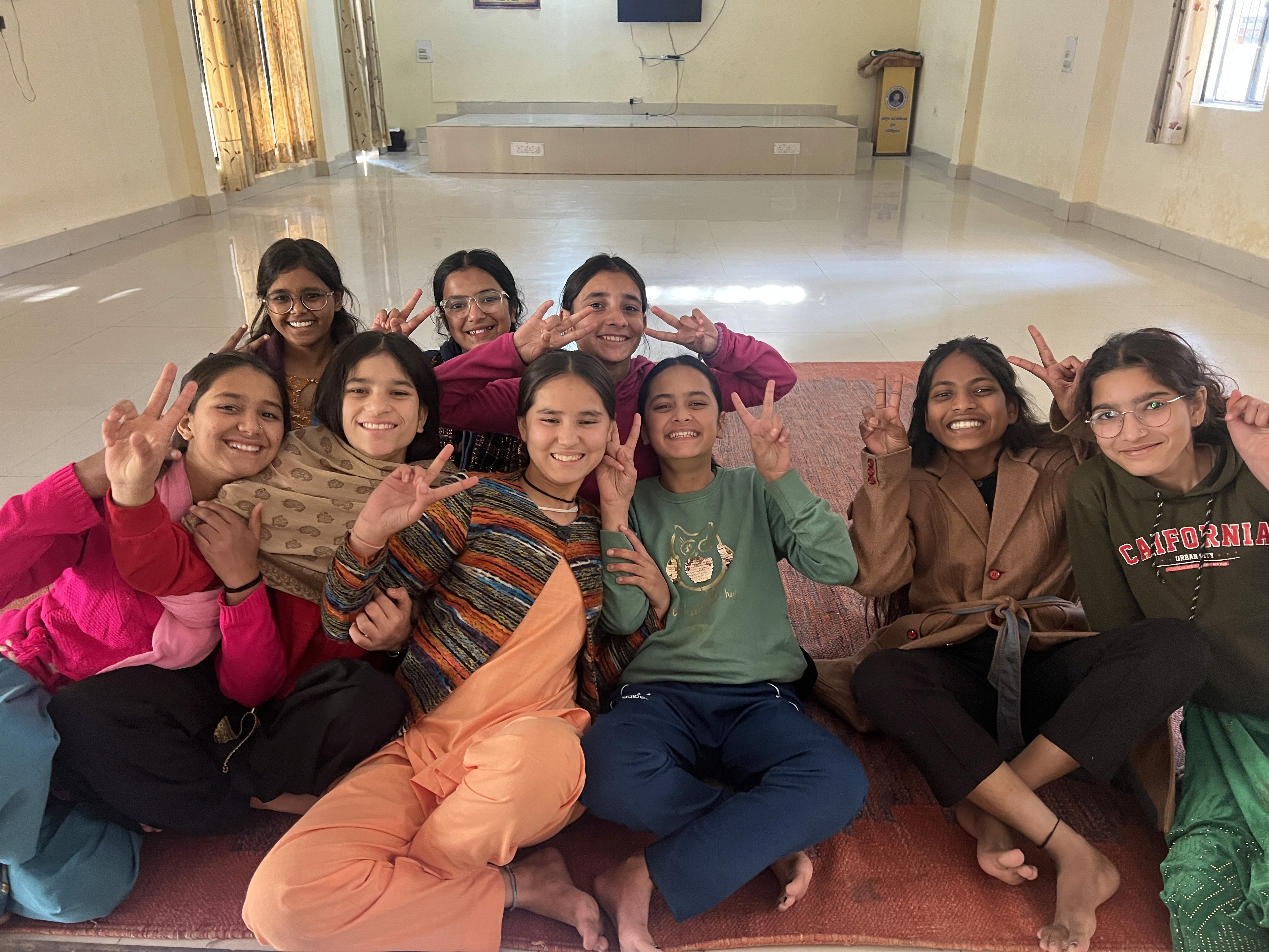 woman holding a phone and man looking at the phone. both are smiling