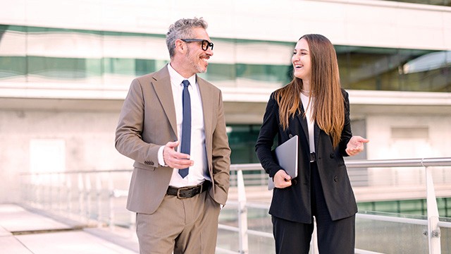 two colleagues walking and talking.