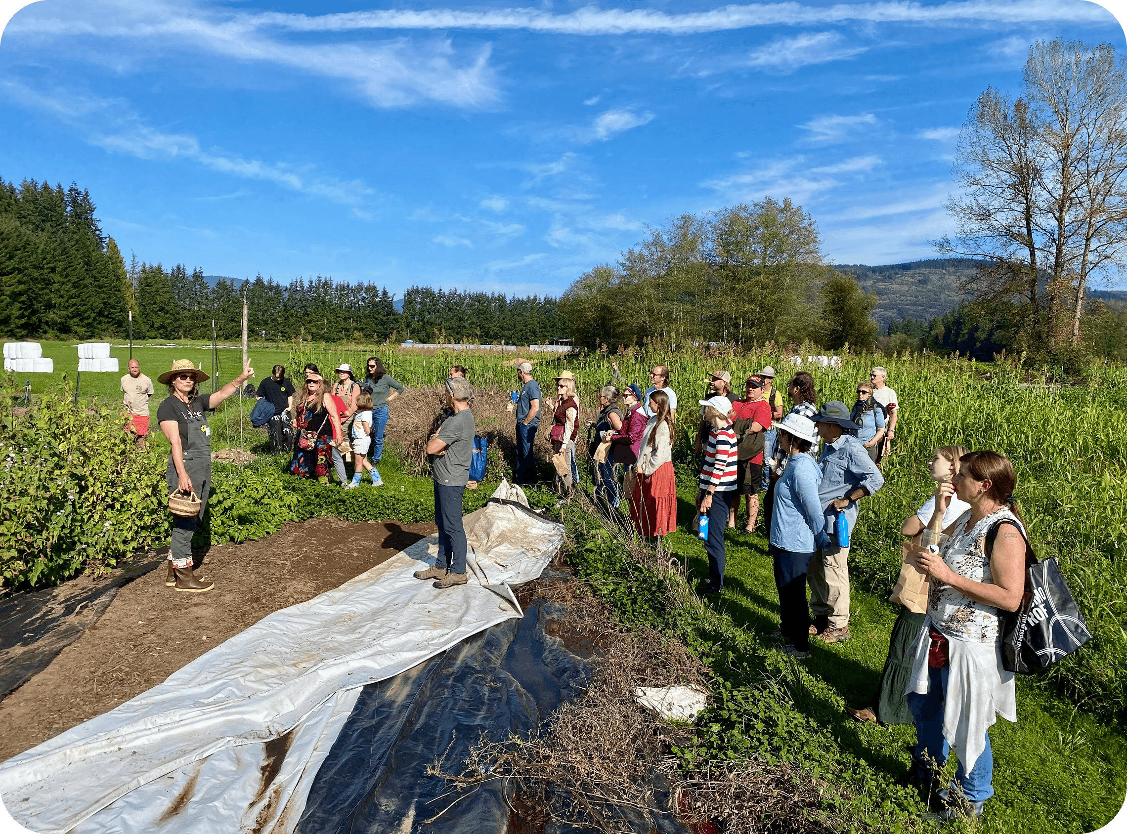 Community members gathered together indoors in conversation during a cohousing meeting.