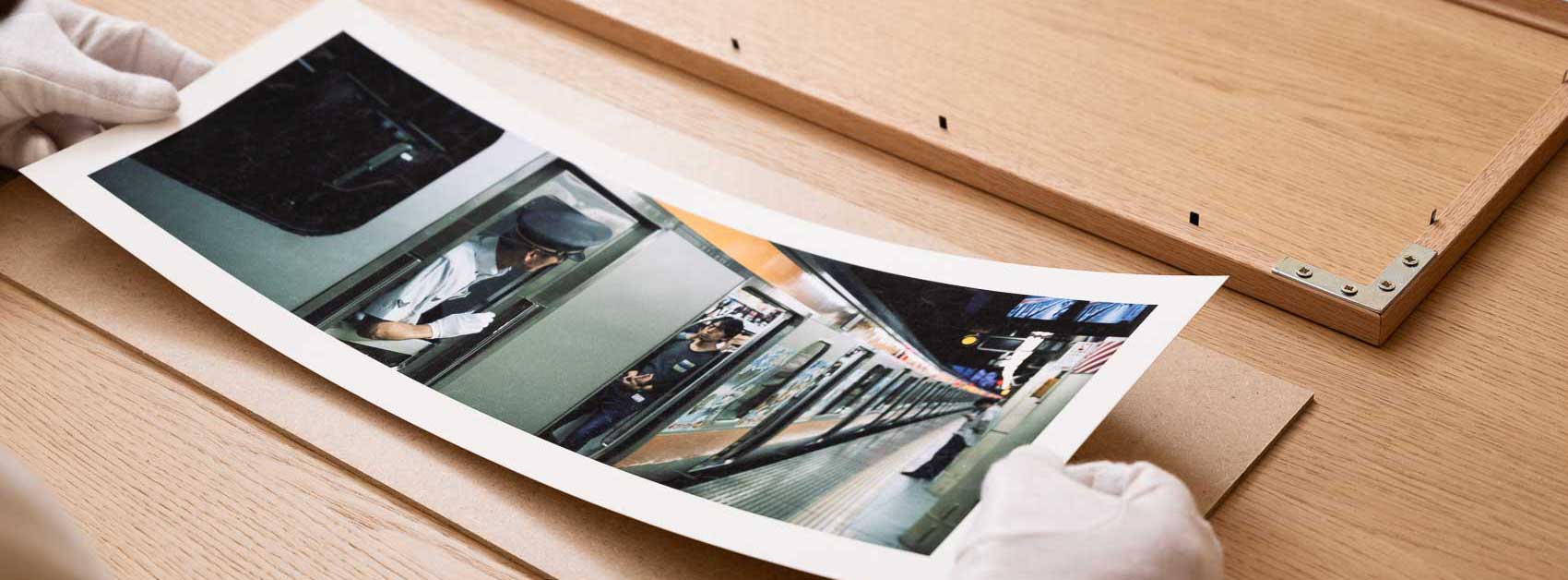 An overview of my fav panoramic print on the wall, panoramic photo print / horizontal art captured on Hasselblad XPan, Photographer placing the matt on the photograph