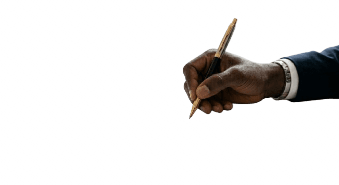A hand holding a black pen, poised to write or draw on a surface.
