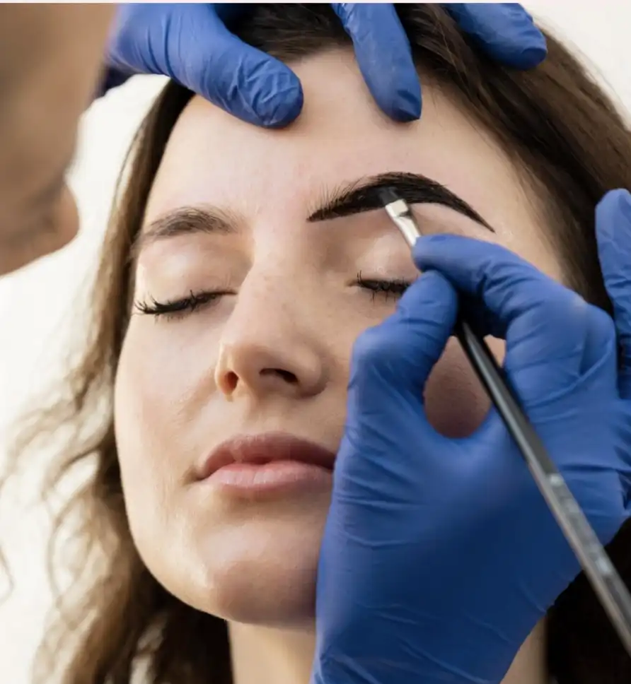 A modern black speaker illuminated by soft light, set against a green background.