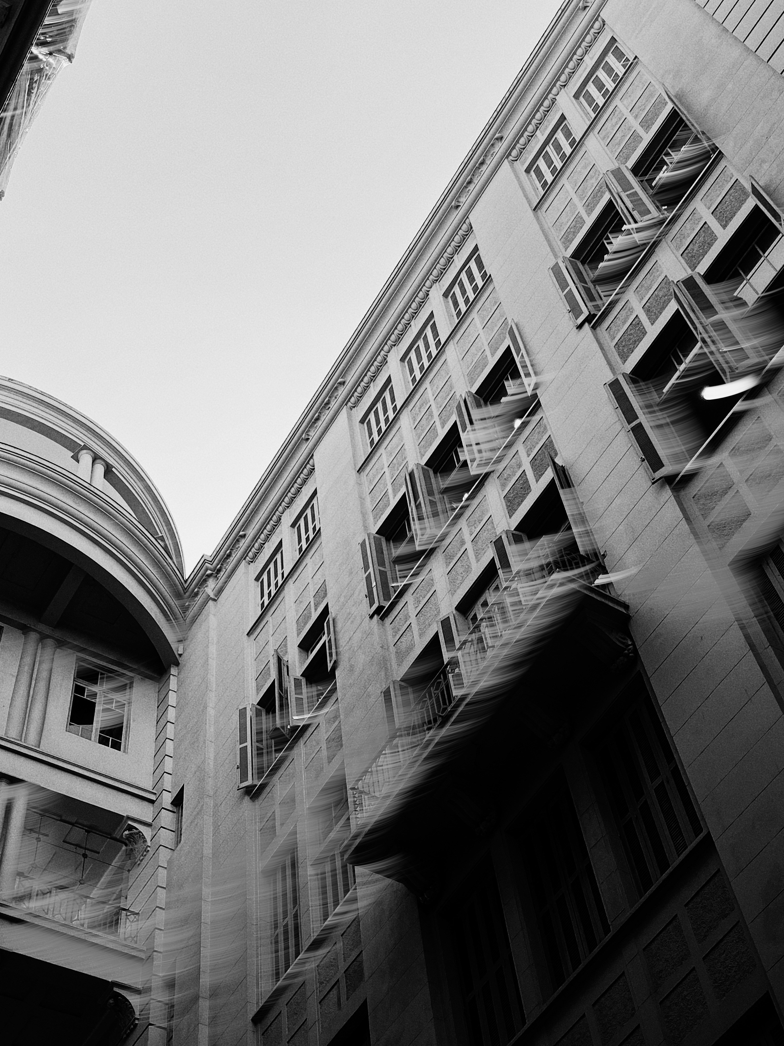 Buildings with many windows against the bright sky.