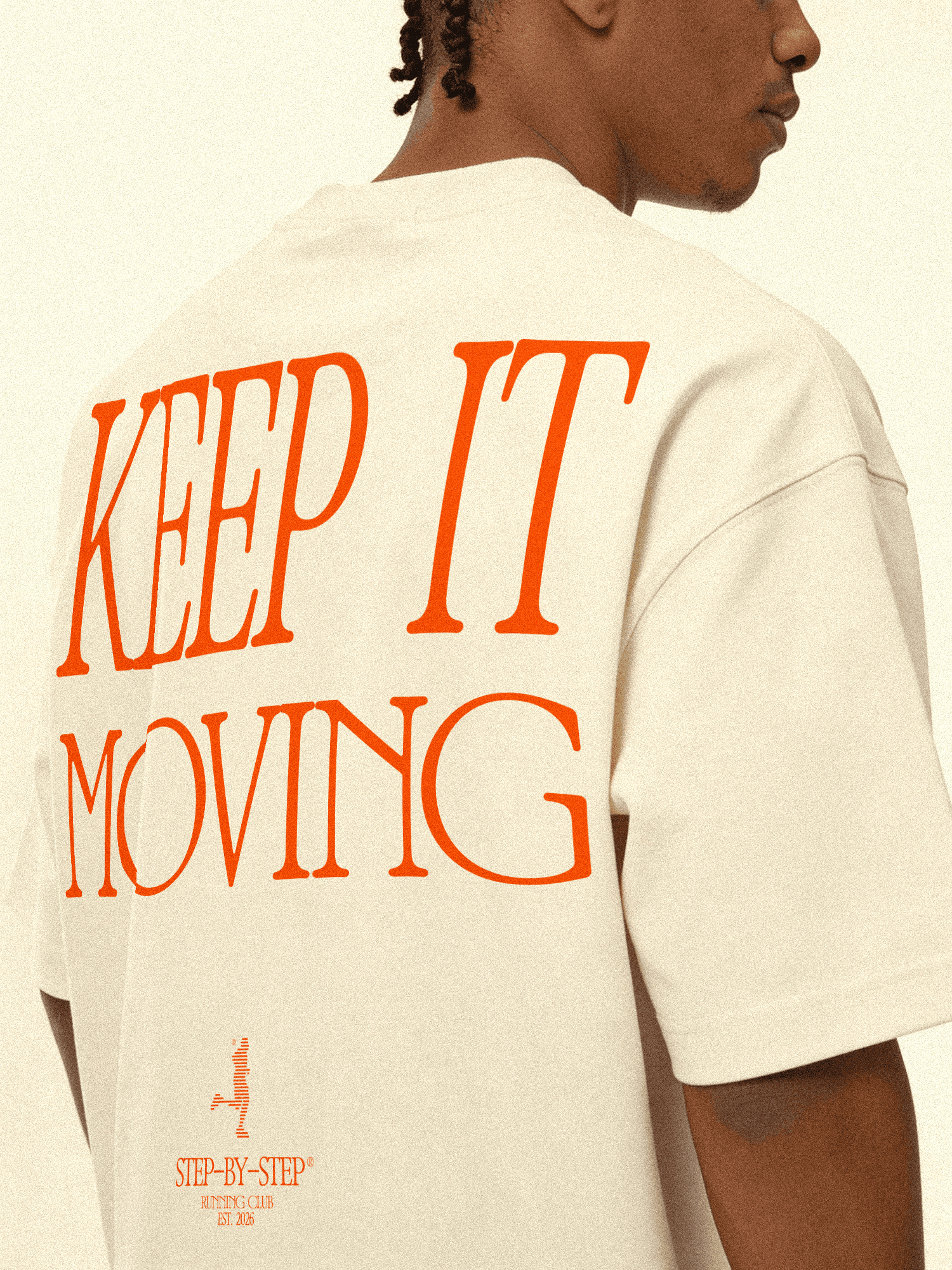 A man wearing a shirt with the words KEEP IT MOVING printed on the back