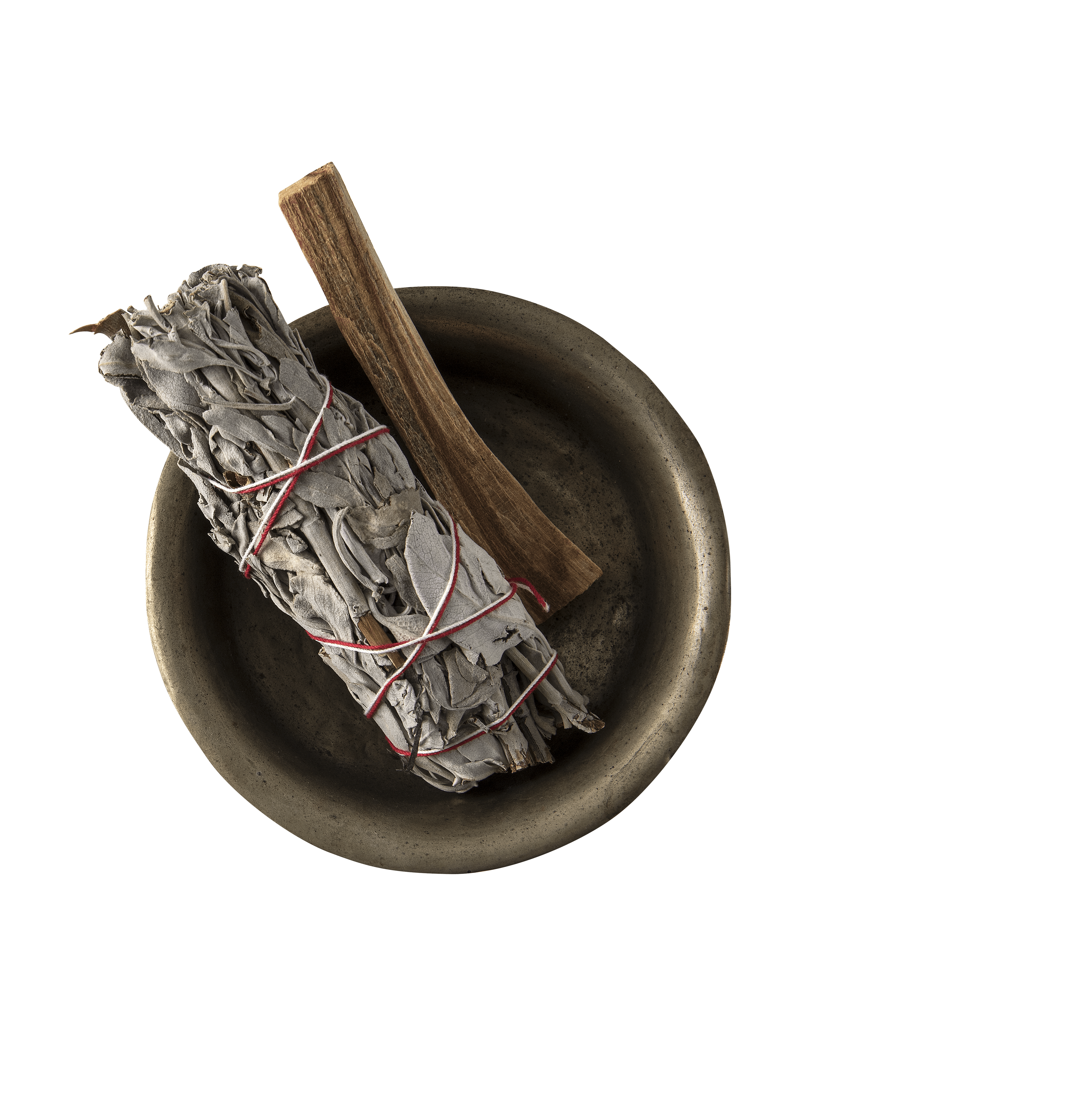 A small bowl containing pieces of wood and herbs, possibly for burning or incense, against a plain background.