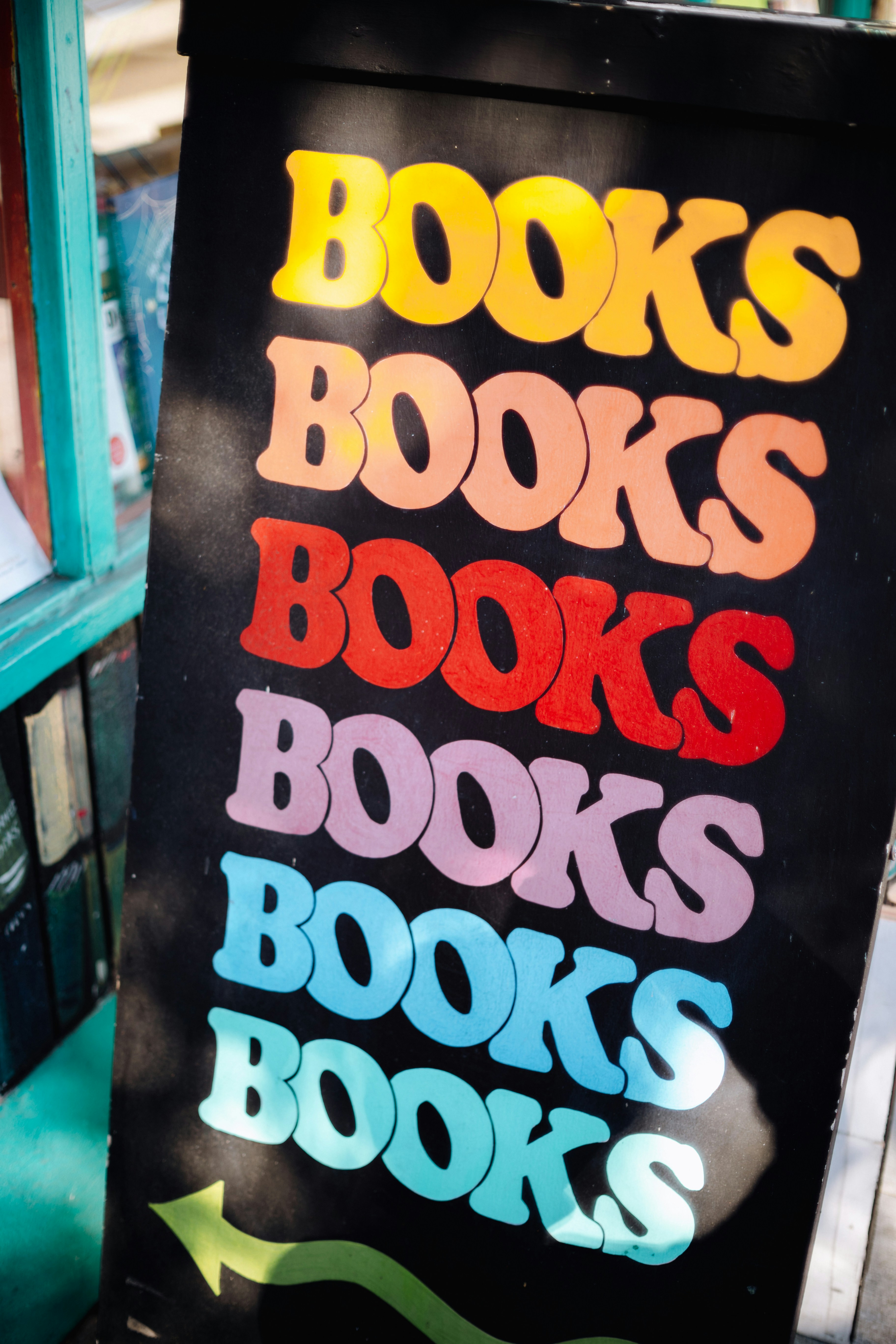 Colorful sign advertising books with an arrow.