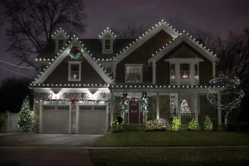 Holiday lighting installation on a Chester County, PA, home with roofline and pathway lights for a festive display.
