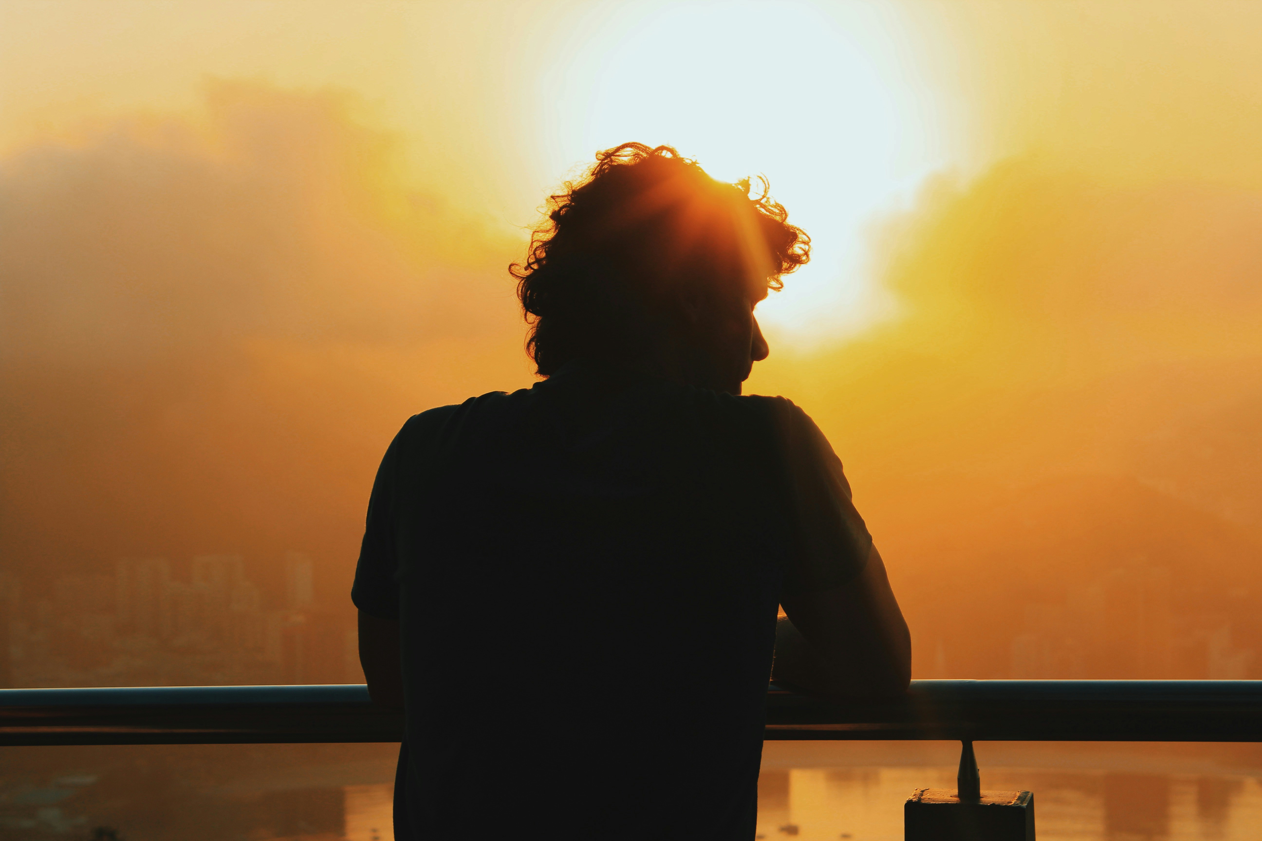 man syanding in sun - Best Time of Day to Get Vitamin D From the Sun 