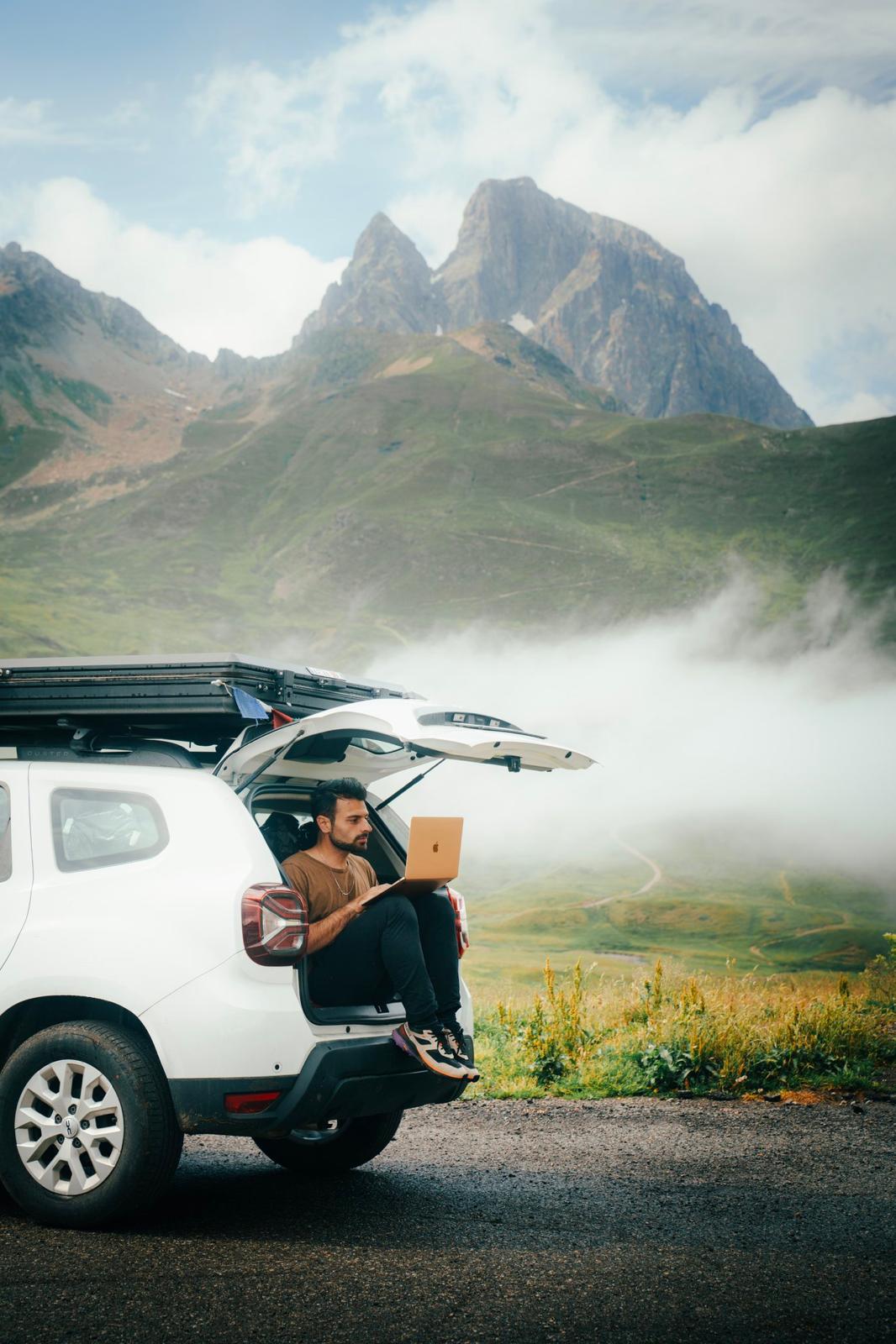 Film clapperboard in focus with glowing orange background, misty street, and silhouettes of people and lights; conveys mystery and anticipation.