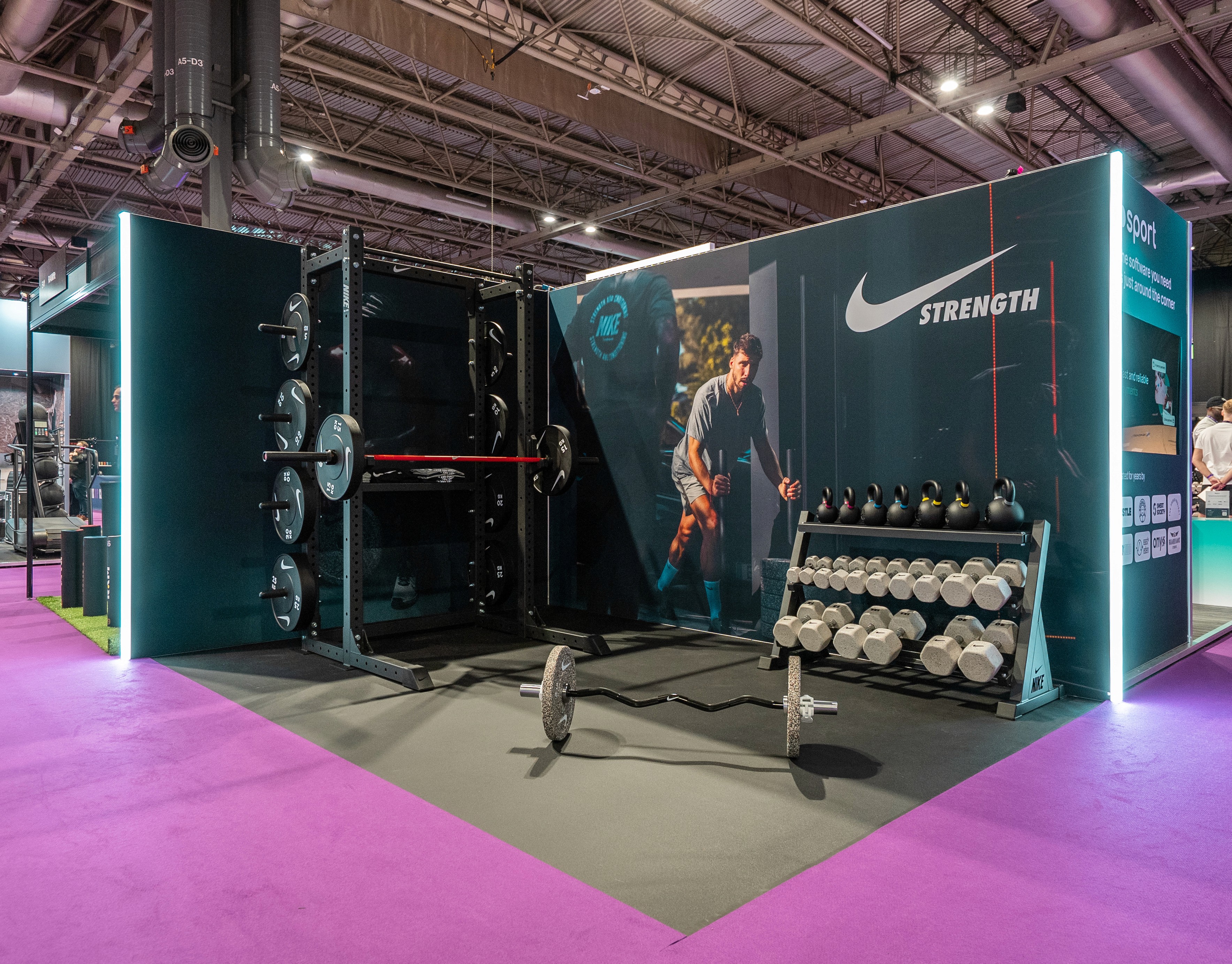Nike Strength gym exhibition stand with weight rack and kettlebells at a fitness trade show, built by EXOVA Events