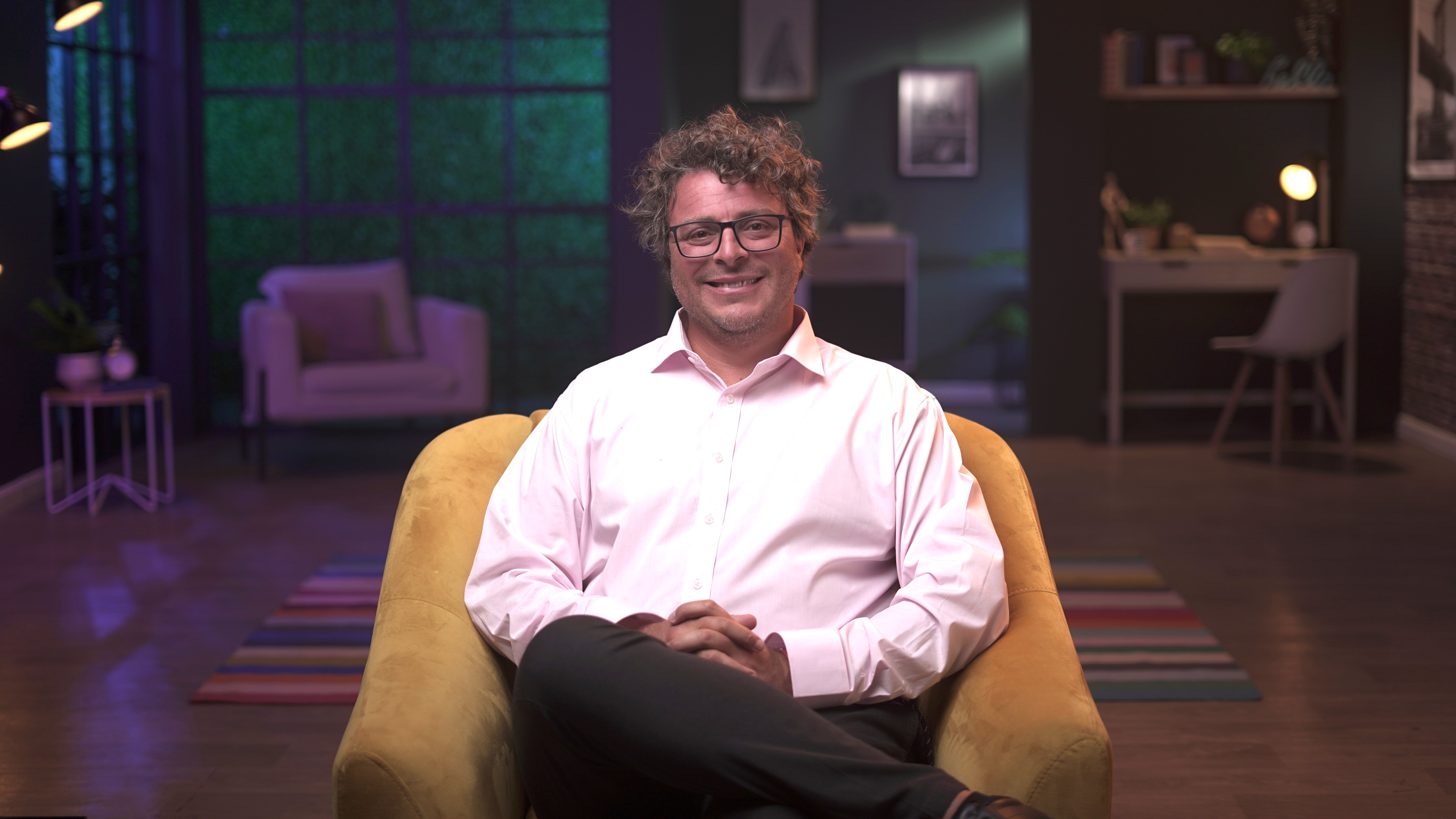 Federico Ast sitting in a studio setting, global educator on Coursera and blockchain technology expert.