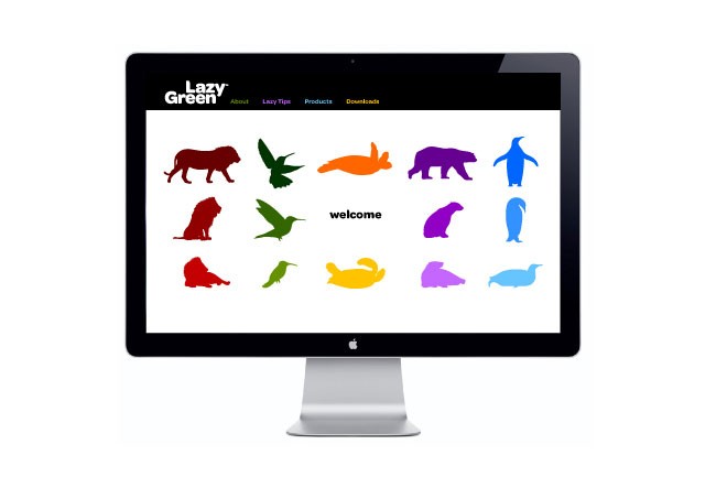 A silver Apple iMac computer displays a webpage titled "Lazy Green." The page features a variety of colorful animal silhouettes arranged in three rows: a red dog silhouette, a green bird silhouette, and a purple bear silhouette. The word "welcome" is centered below the animal silhouettes. The top navigation bar includes "About," "Lazy Tips," "Products," and "Downloads." The background is white, and the computer is positioned against a plain white backdrop.