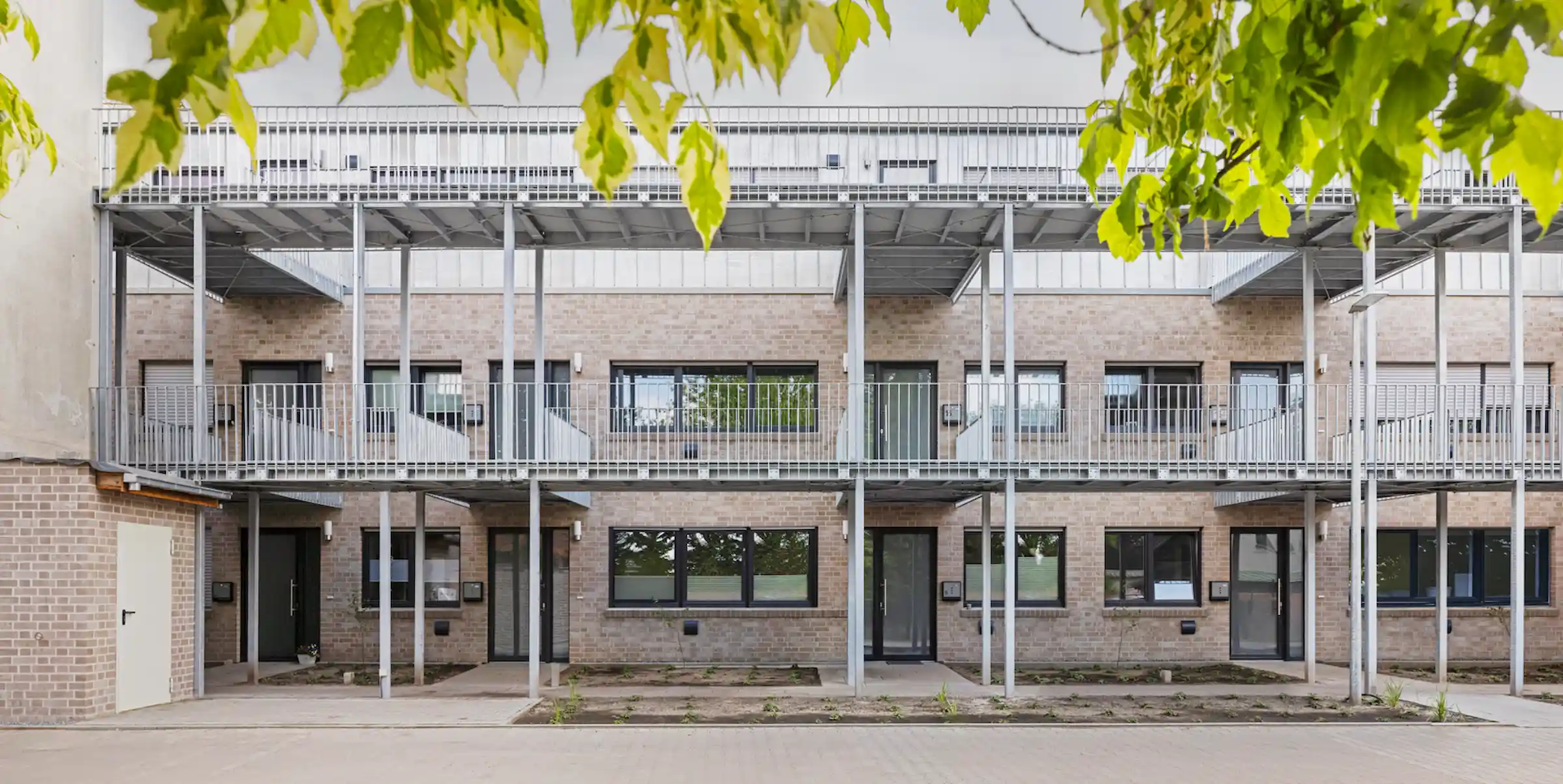 Isometrische Zeichnung eines Bauprojekts mit mehreren Gebäuden und markierten Strukturen in Rot
