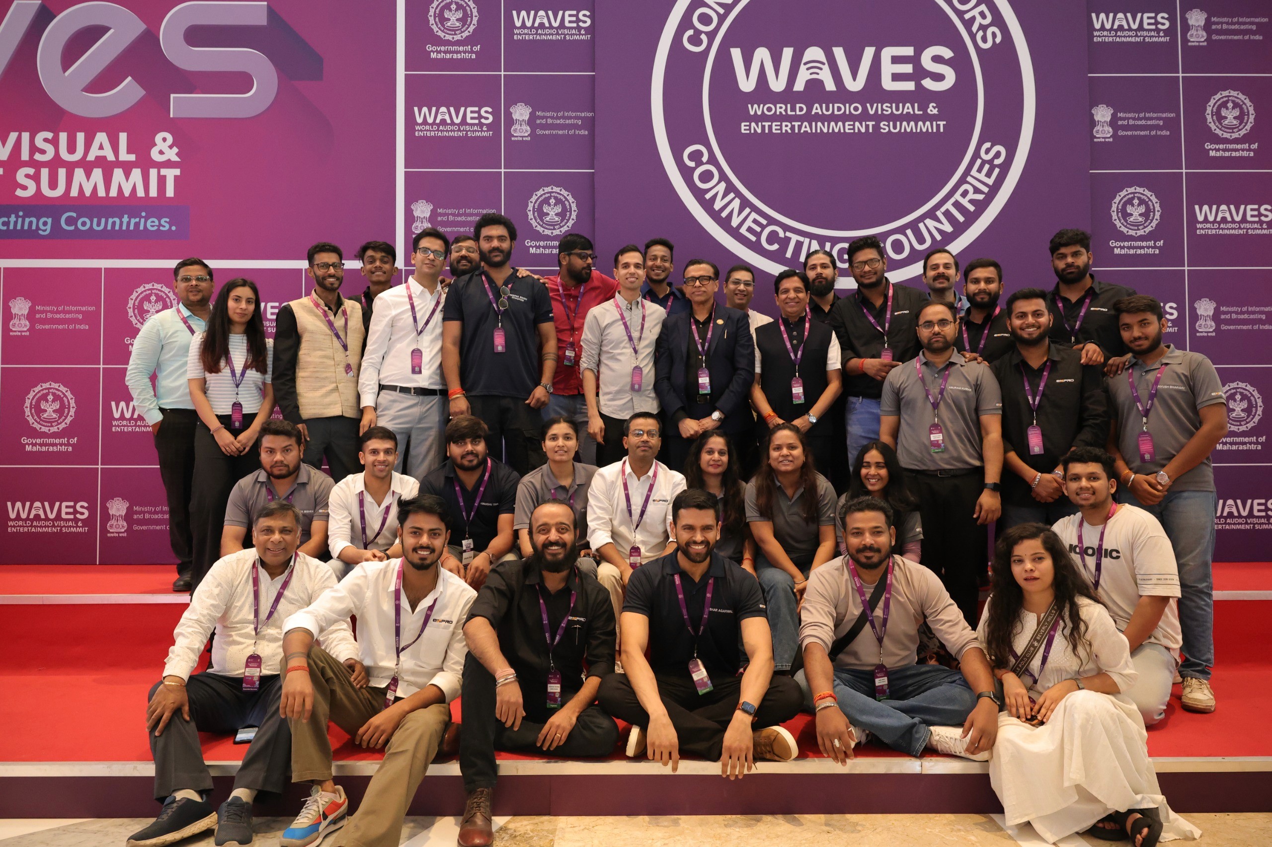 Two filmmakers operate a large camera in a dimly lit studio, wearing headphones and focused intently on the screen, conveying concentration.